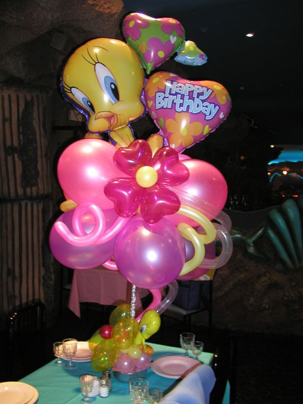 Tweety Bird balloon centerpiece with heart and flower balloons. Pink and yellow on a teal table.