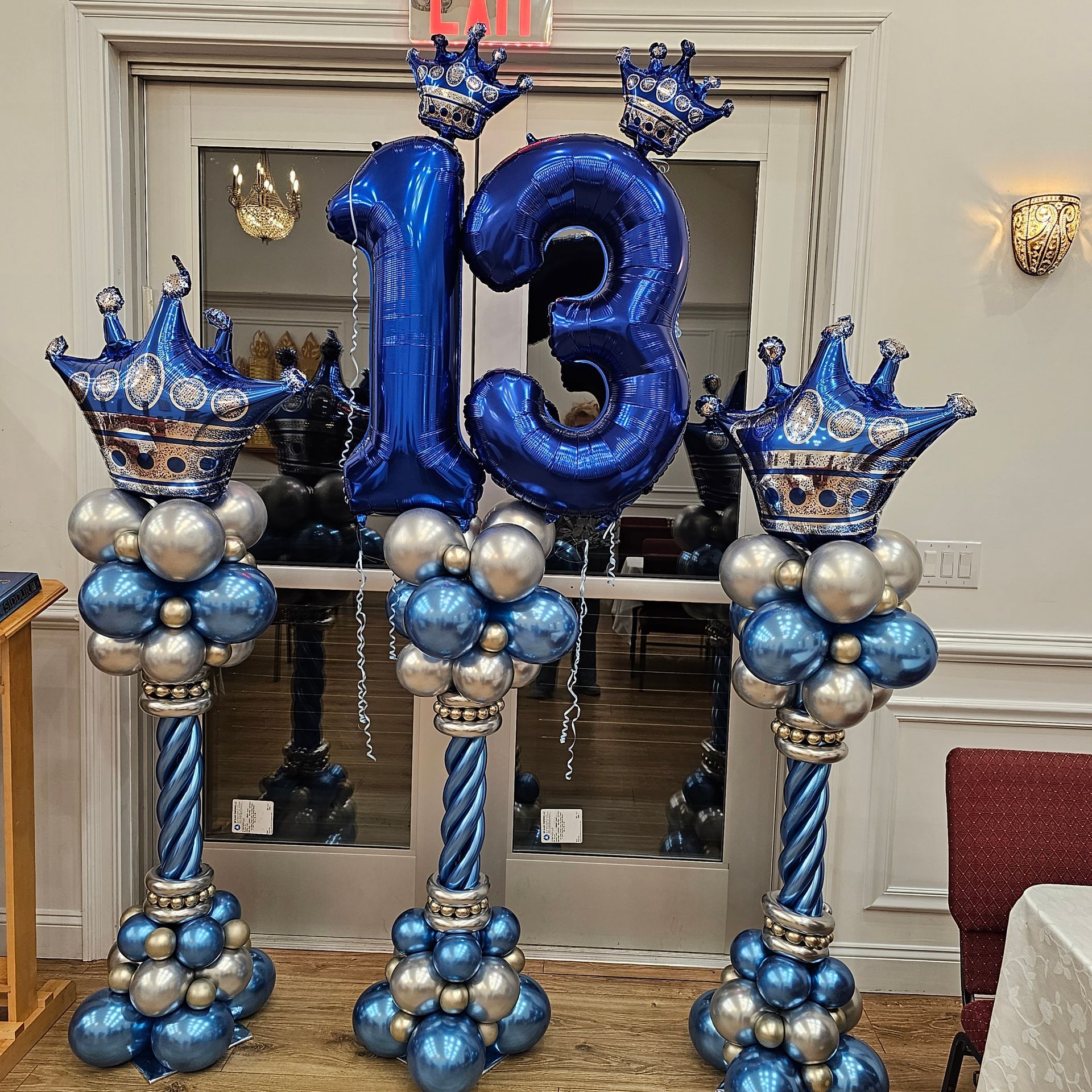 Blue and silver balloon decorations for a 