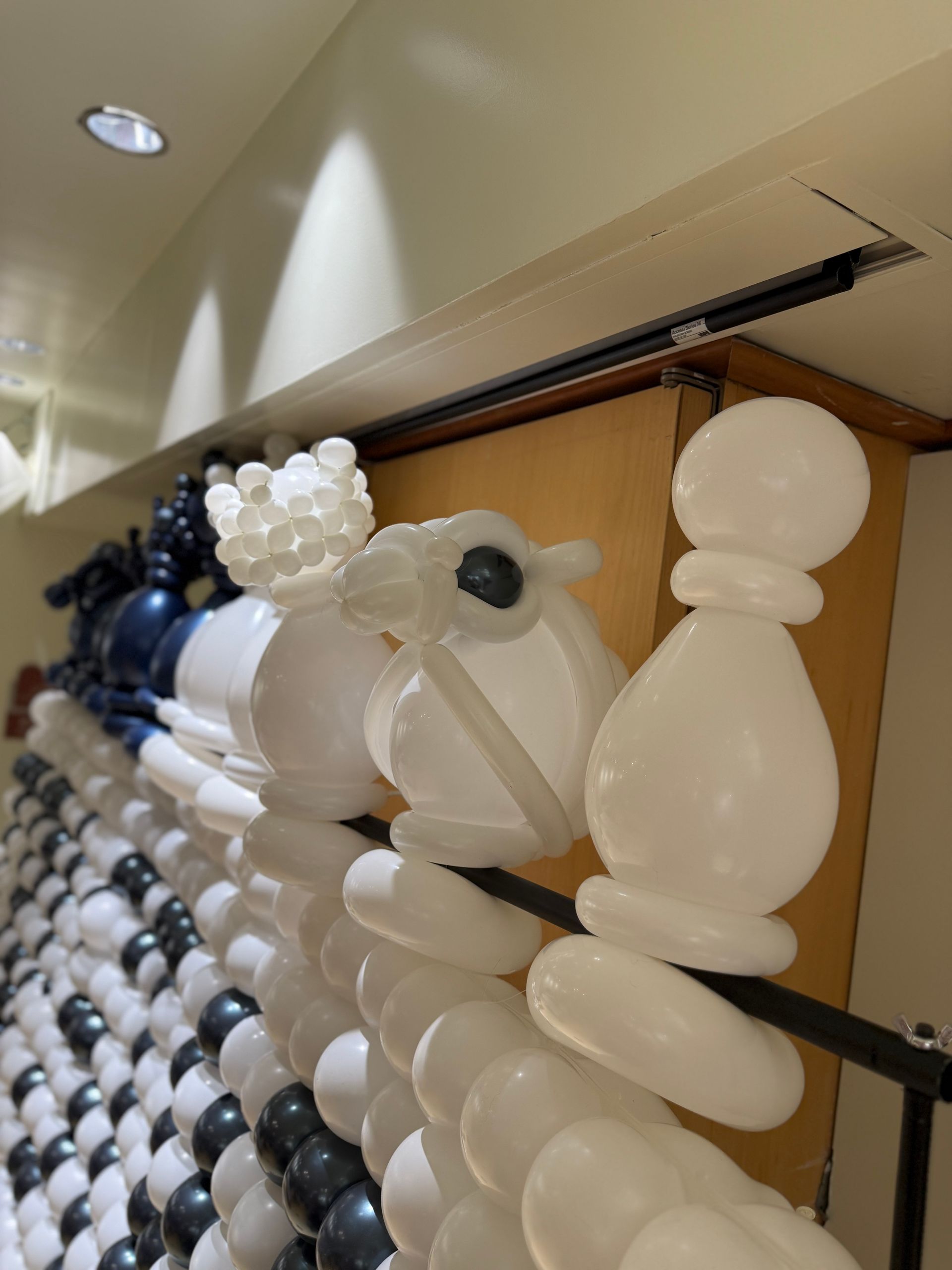 Balloon chess set. White and black balloons form chess pieces, like a rook, knight, and pawn.