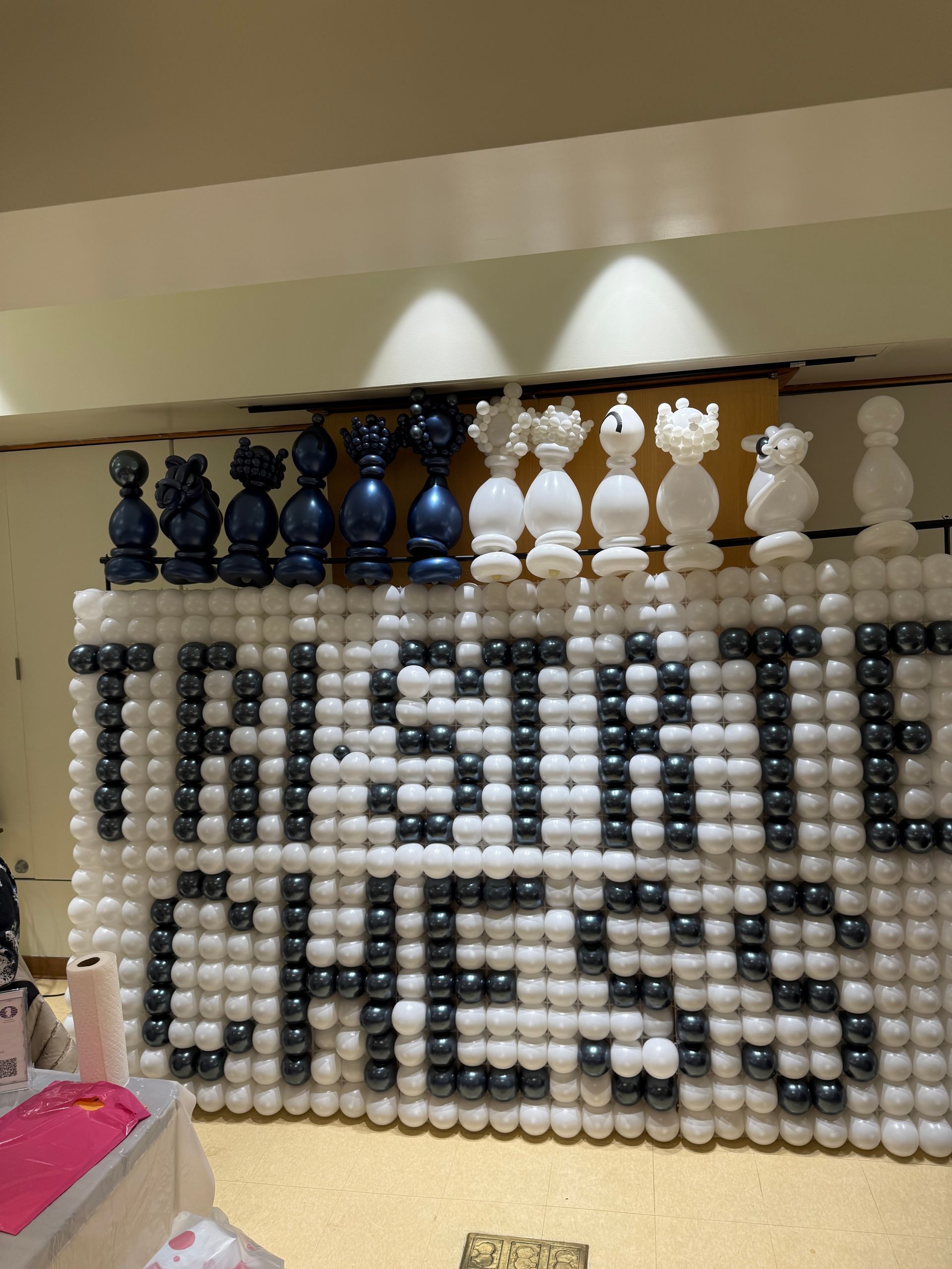 Chess pieces atop a wall spelling 