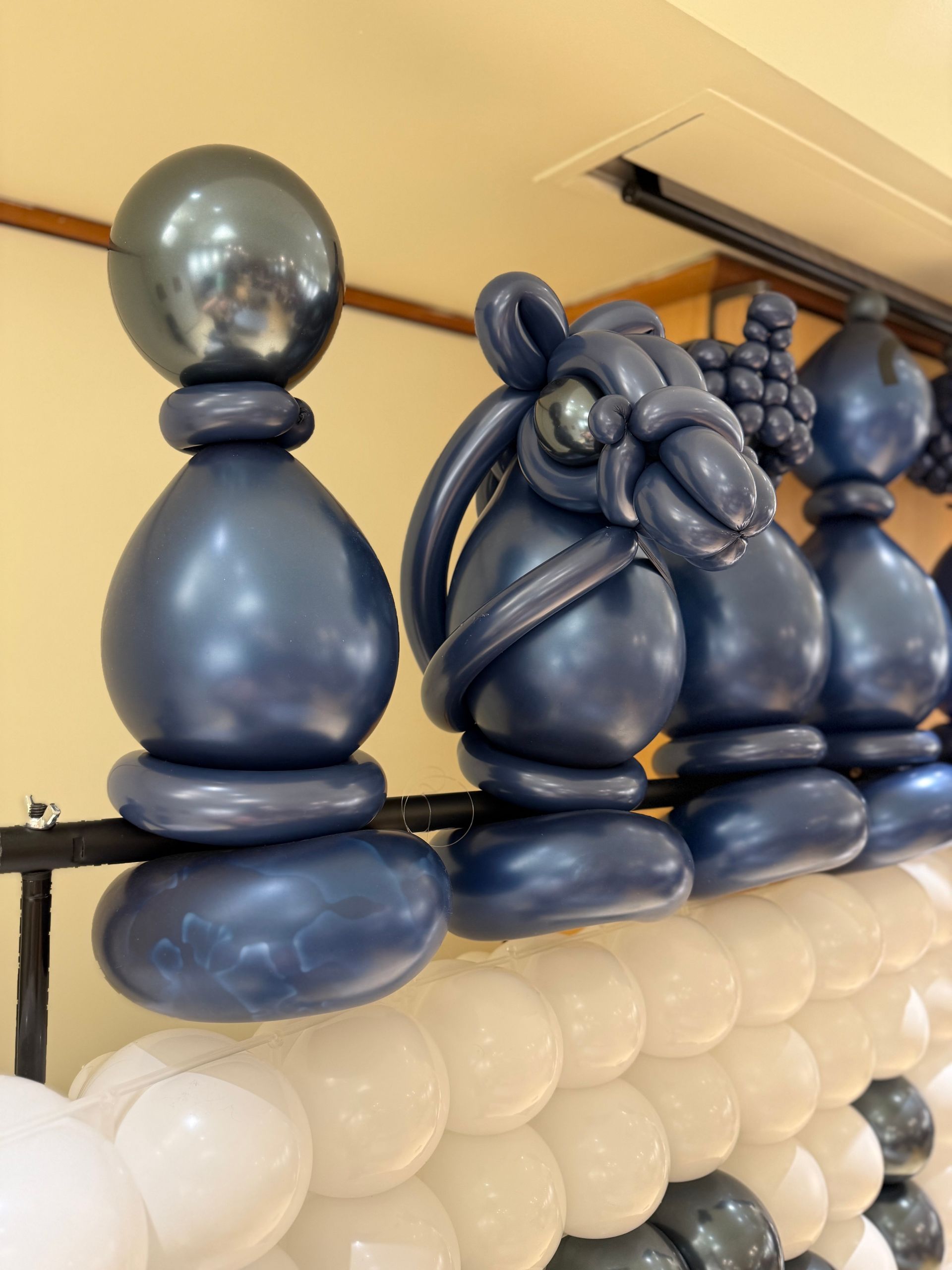 Balloon chess set with navy and white pieces.