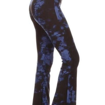 Blue tie-dye flare pants on a white background.