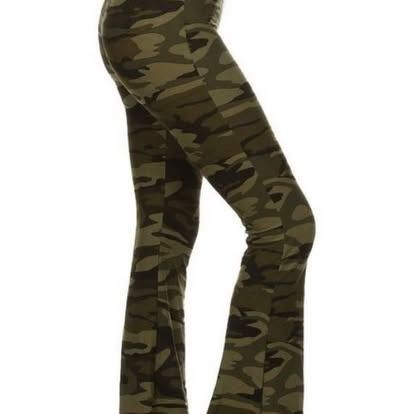 Camo print flared pants on a person's legs, viewed from the side, on a white background.
