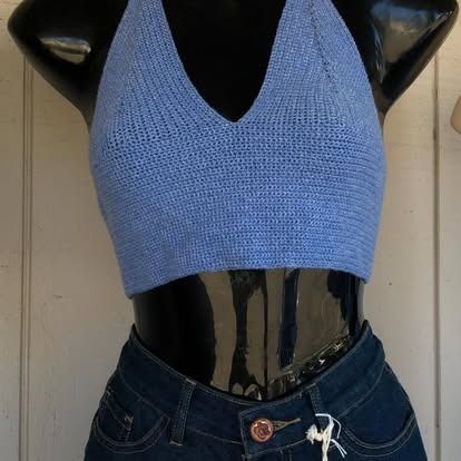 Blue crocheted halter top and denim jeans on a mannequin.
