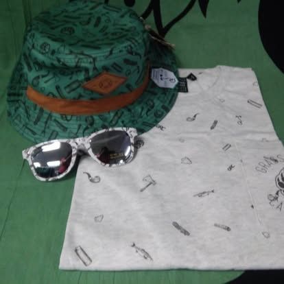 Green bucket hat, sunglasses, and t-shirt with a similar pattern on a green background.