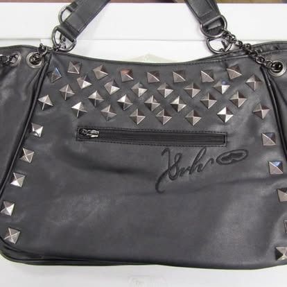 Black tote bag with silver studs and a zippered pocket.