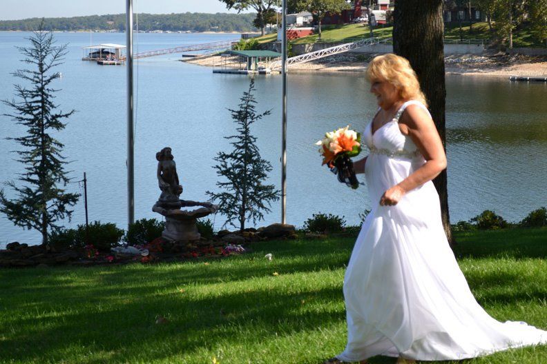 bride walking along lakeside