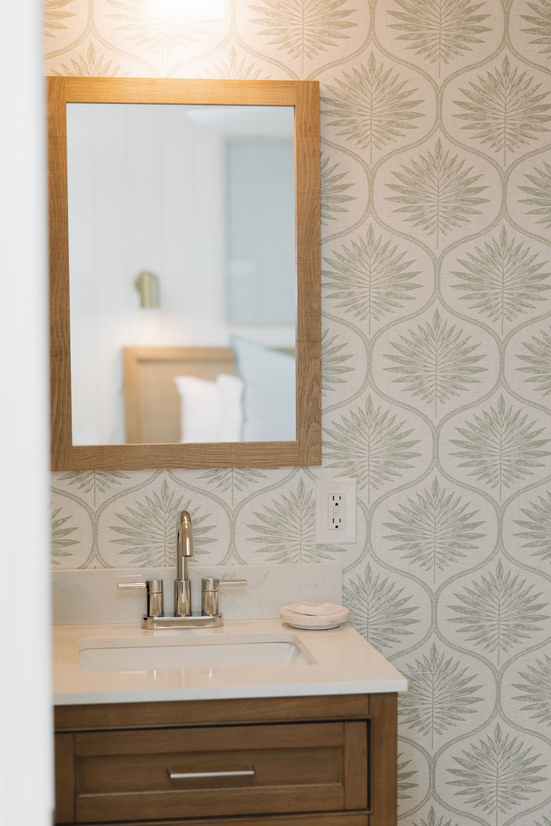 A bedroom with a fireplace and a flat screen tv on the wall.