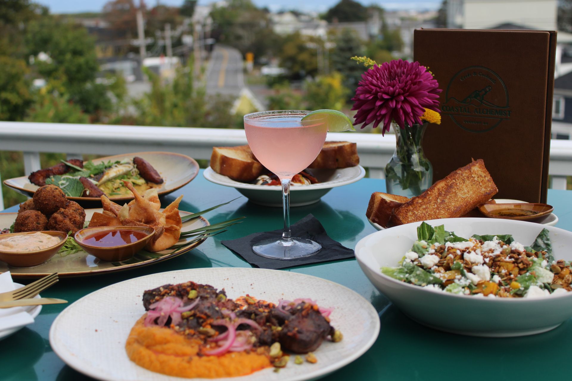 A view from the balcony, a sailboat in the background.