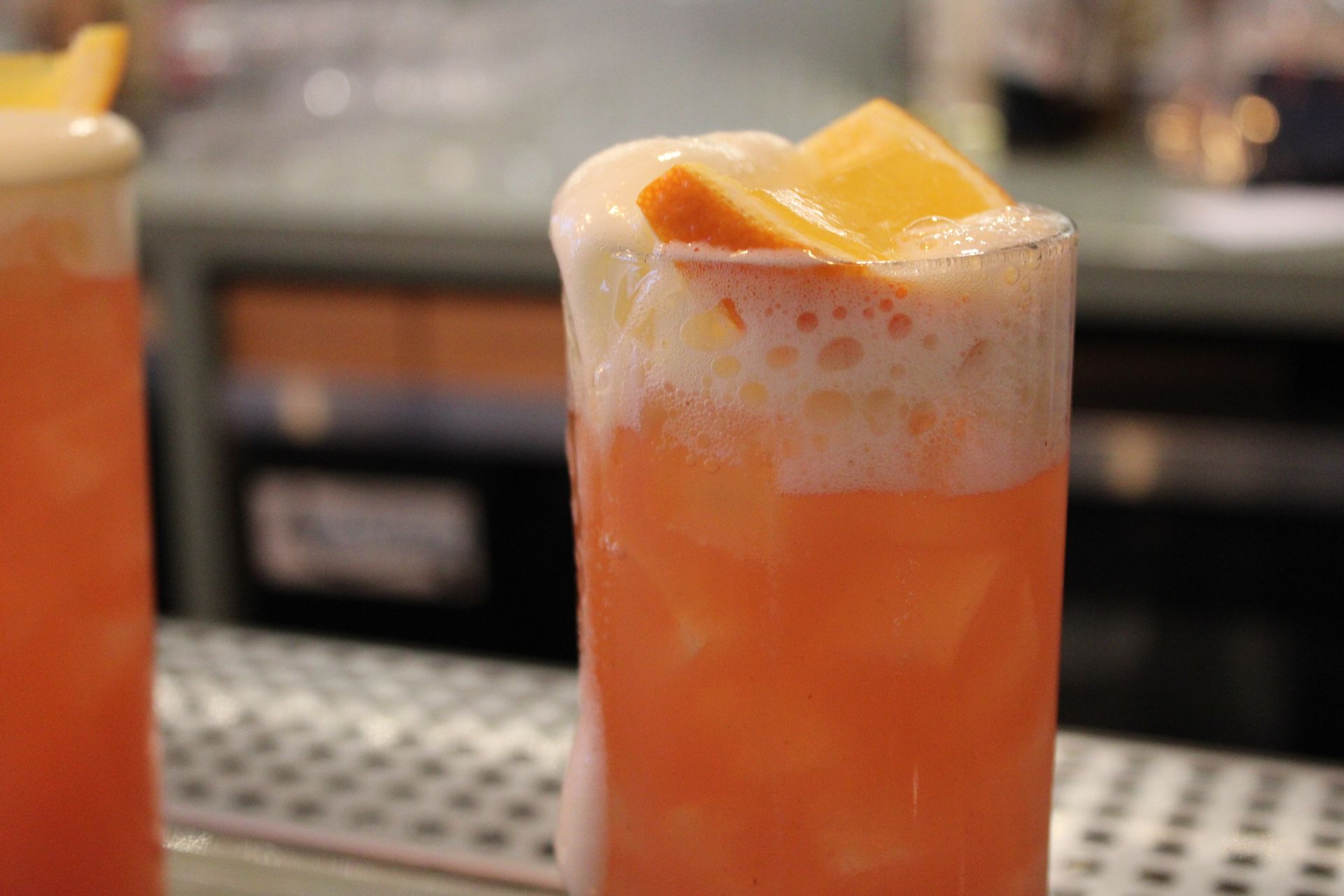 A close up of a shrimp cocktail on a plate on a table.