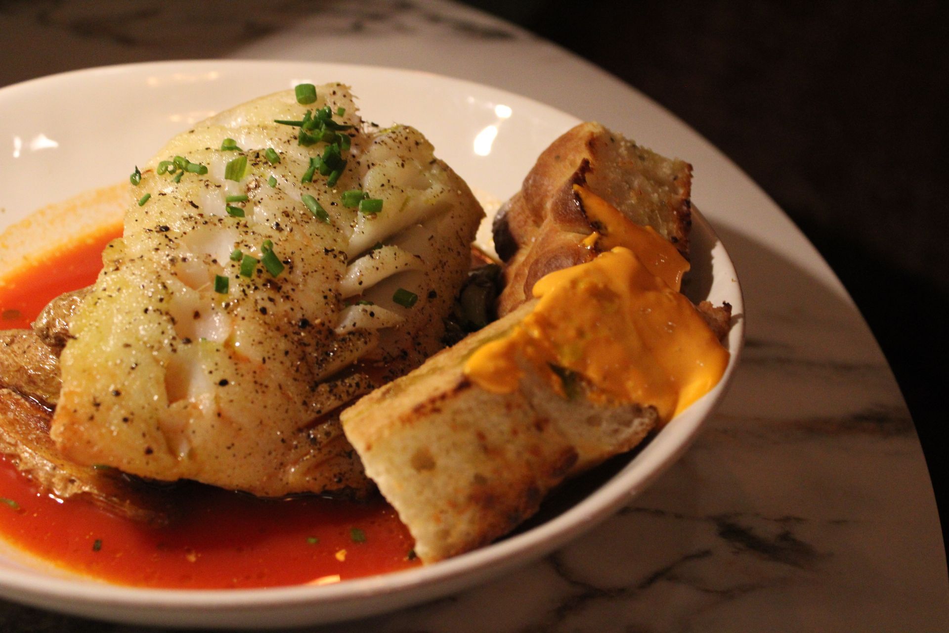 A plate of food with a fire pit in the background.