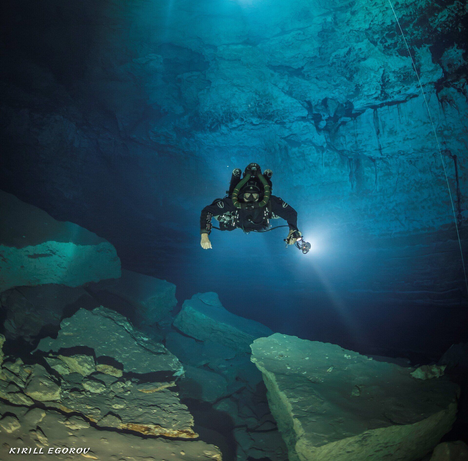 Scuba diver with light in a cave