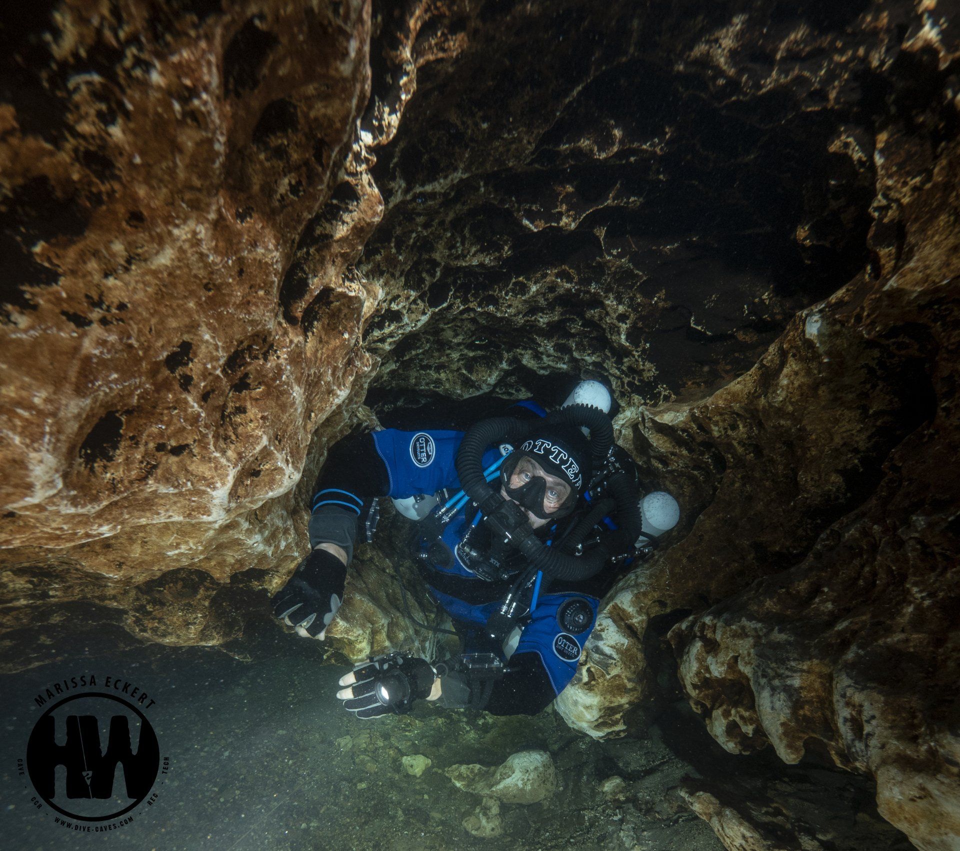 Scuba divers explore underwater caves