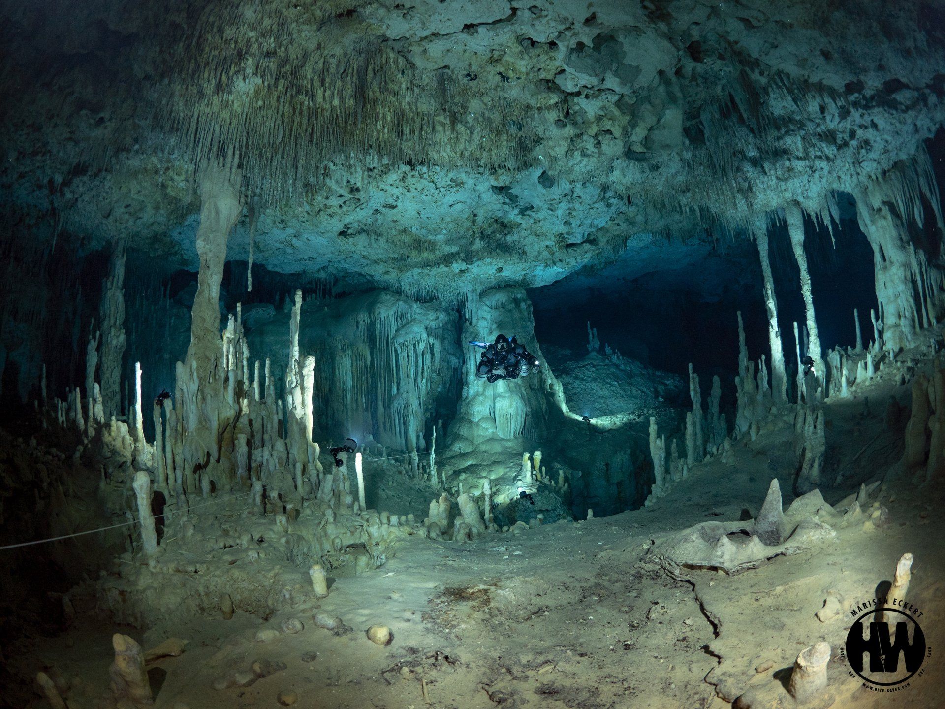 Scuba divers explore underwater caves
