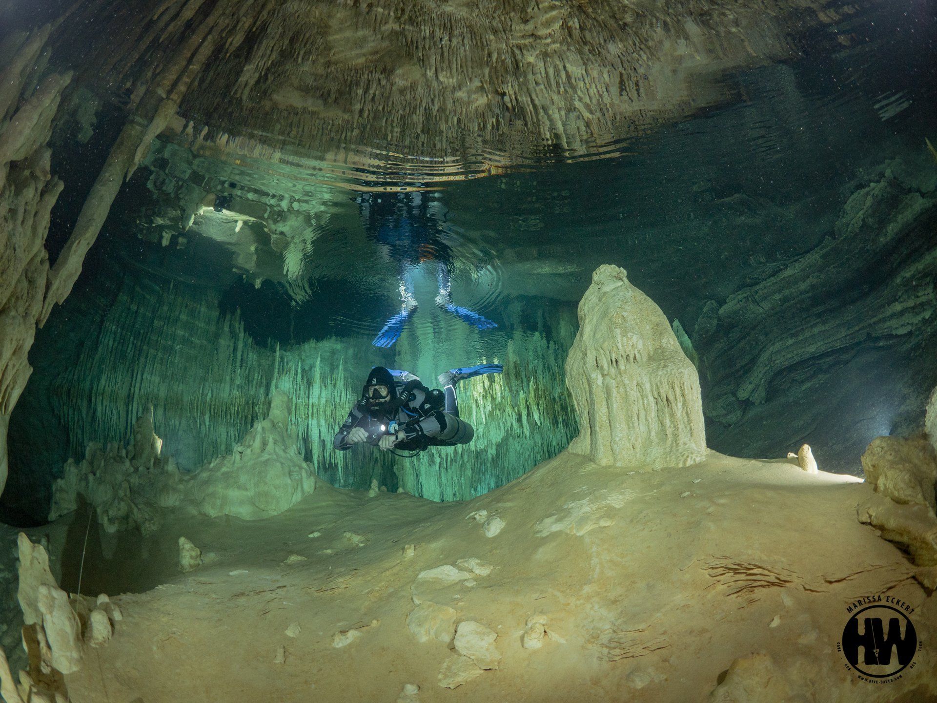 Scuba divers explore underwater caves