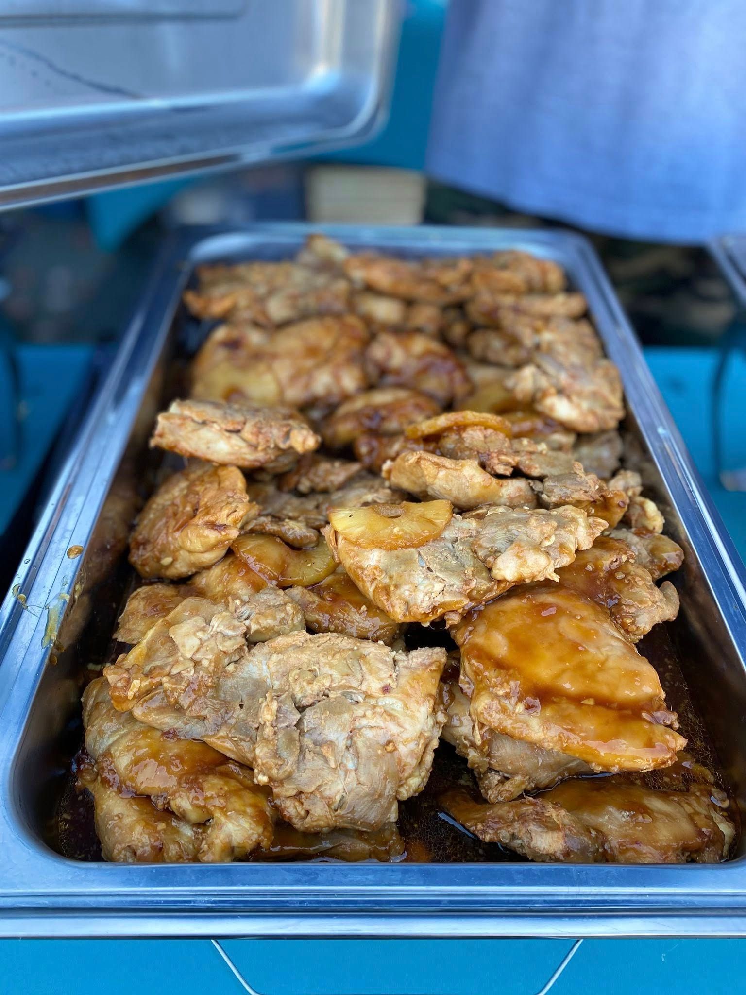 Tray of fried chicken thighs, golden brown and glazed, ready to serve.