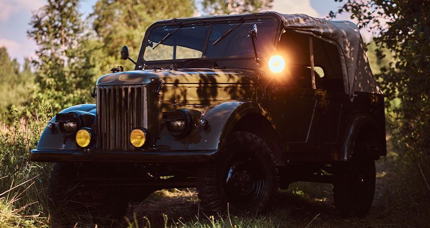 Old jeep parked in the middle of a forest