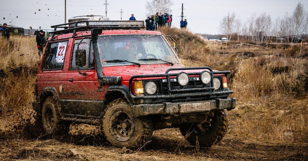 A black truck is driving down a dirt road.| Gemba Automotive