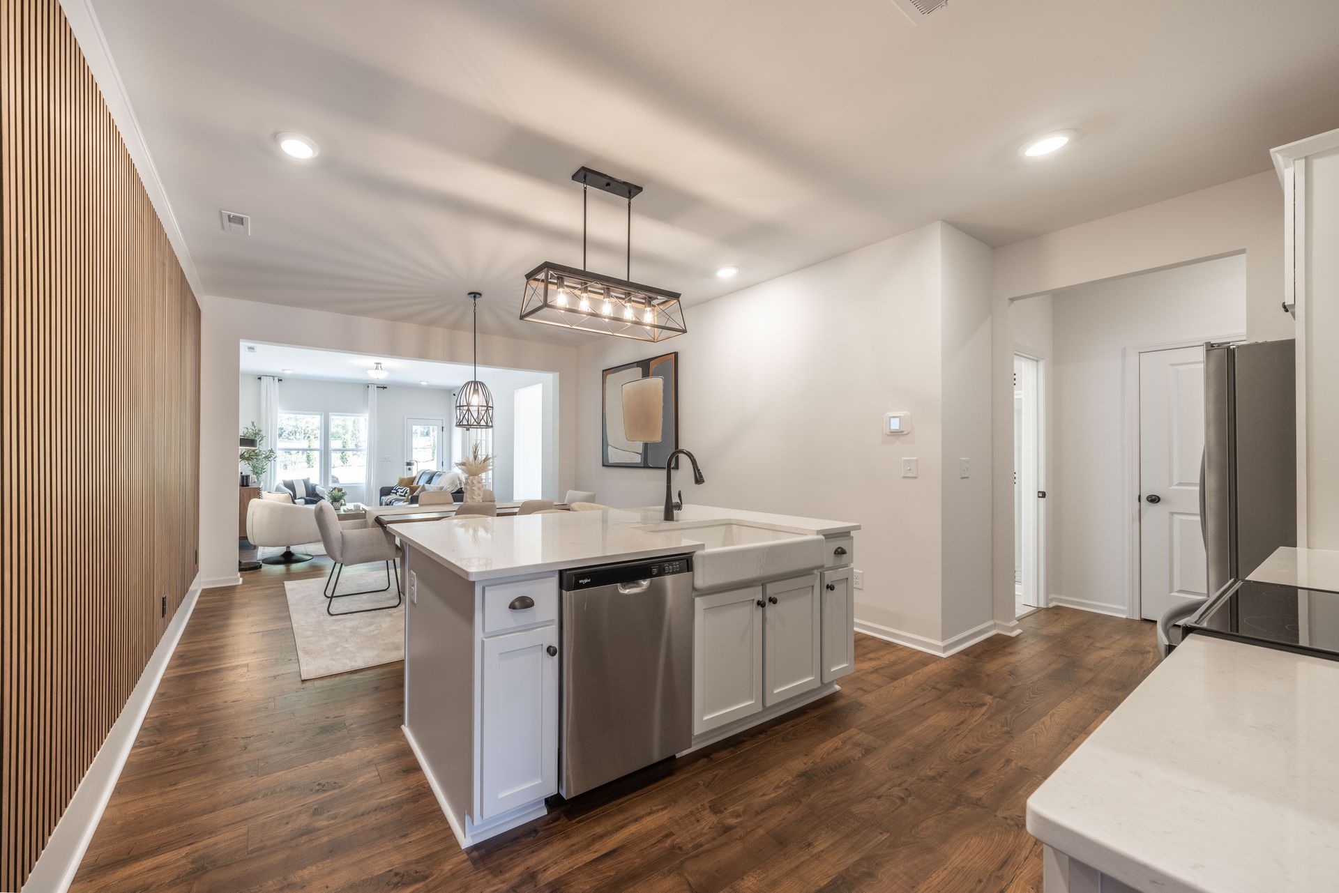 A kitchen with a large island and stainless steel appliances - Abigale Floorplan by True Homes.