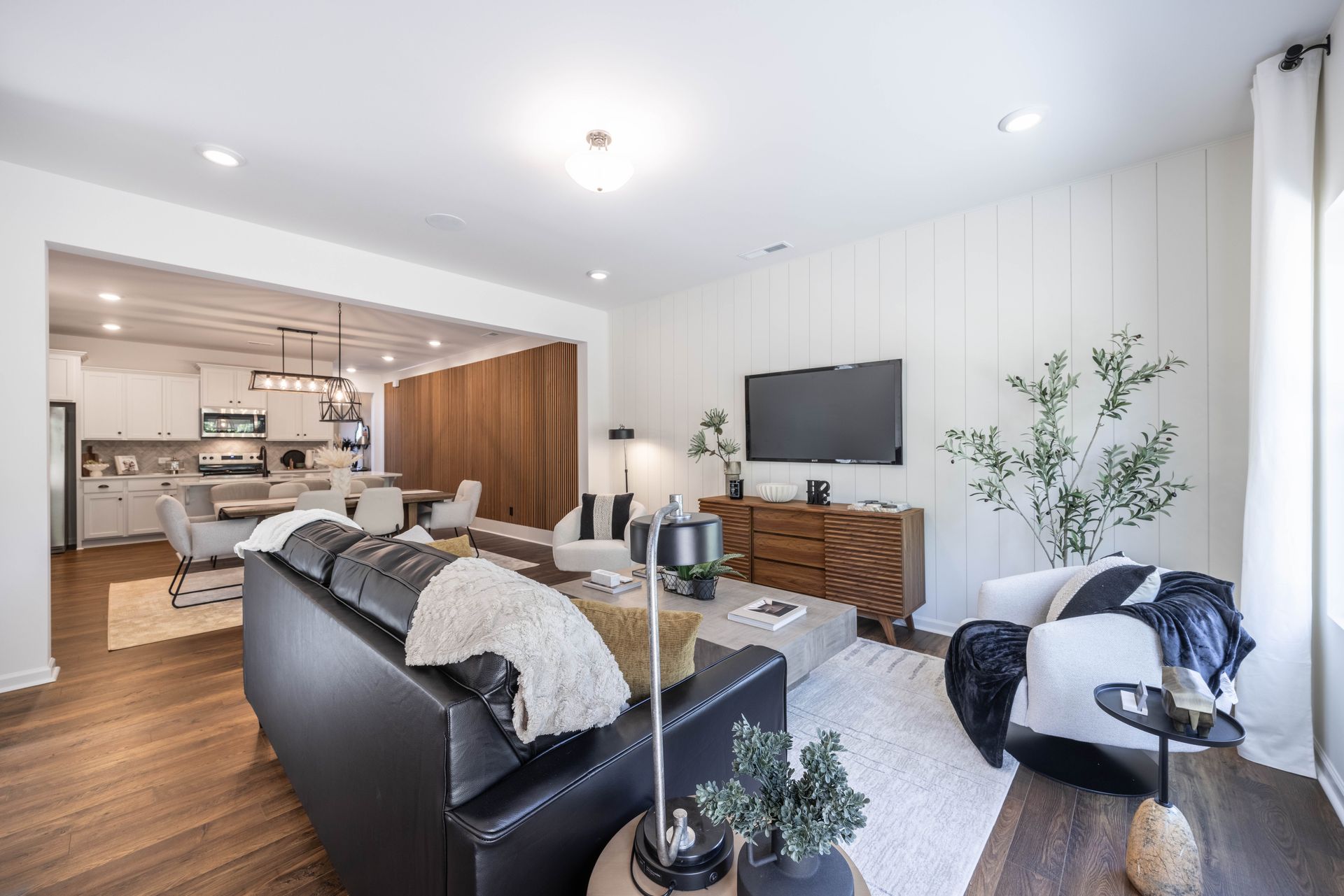 A living room filled with furniture and a flat screen tv - Abigale Floorplan by True Homes.