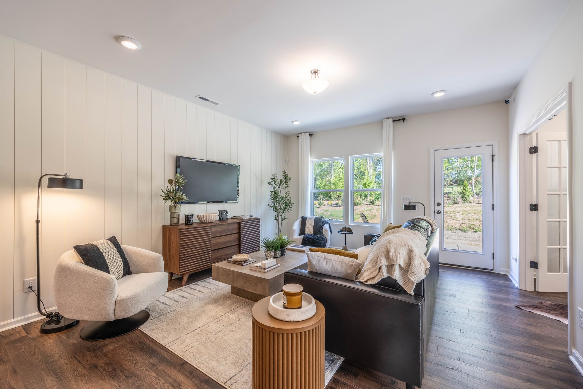 A living room with a couch , chair , coffee table and television - Abigale Floorplan by True Homes.