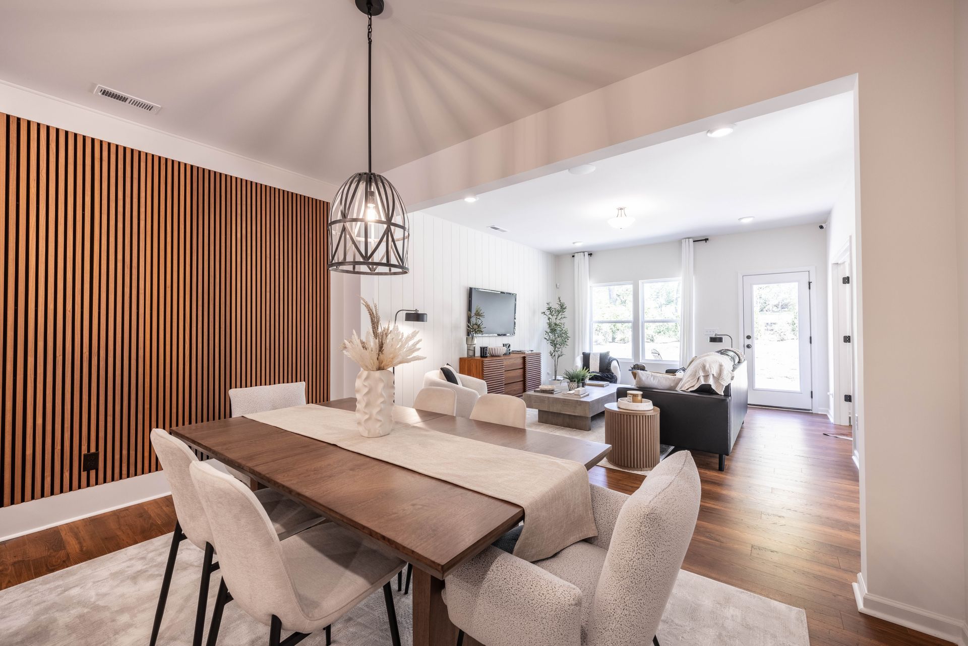 A dining room table and chairs in a living room - Abigale Floorplan by True Homes.