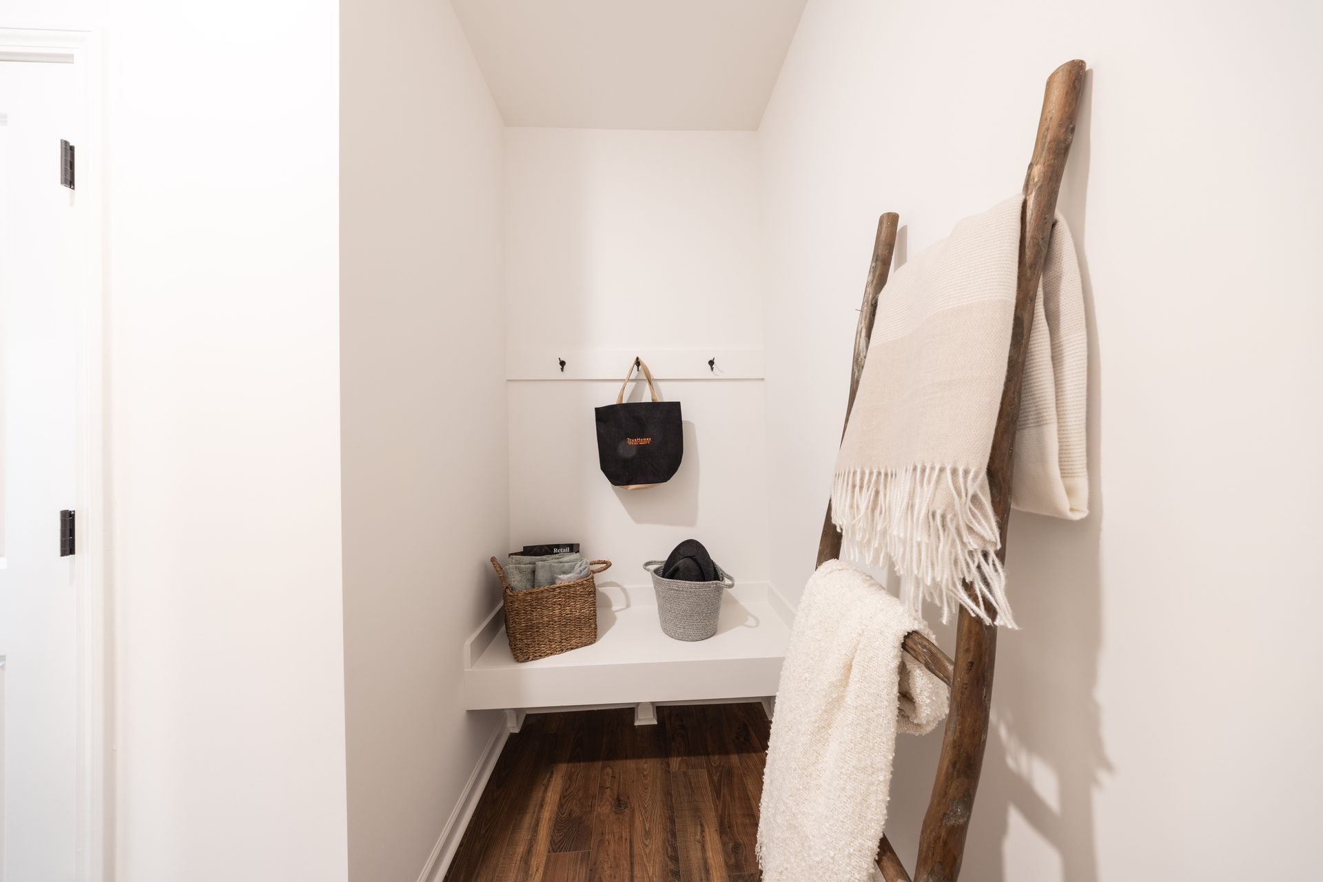 A ladder is hanging from the wall in a hallway - Abigale Floorplan by True Homes.