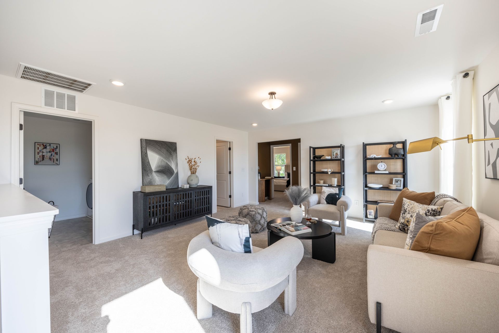 A living room with a couch , chairs , and a coffee table - Abigale Floorplan by True Homes.