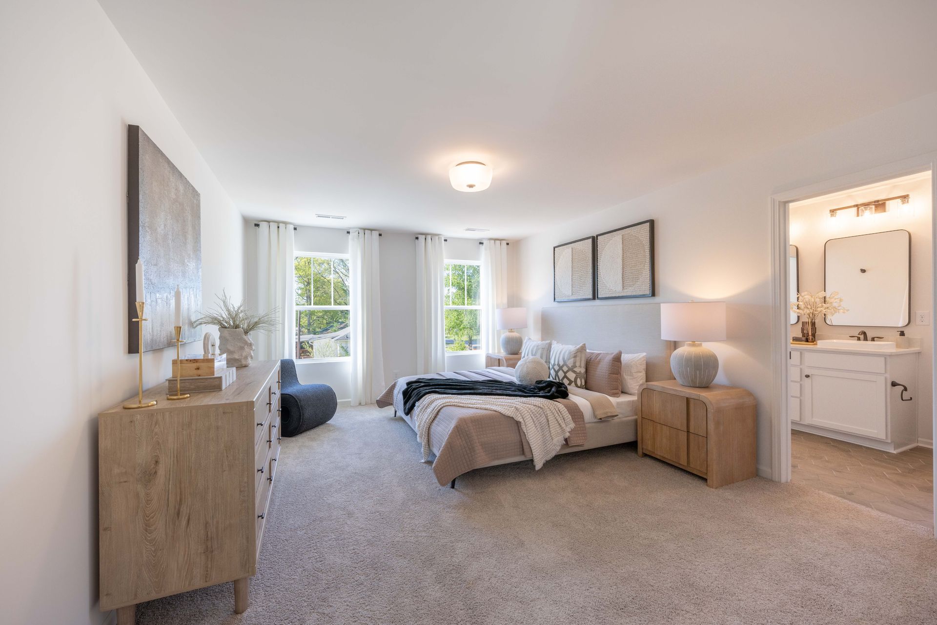 A bedroom with two beds , a dresser , and a bathroom - Abigale Floorplan by True Homes.