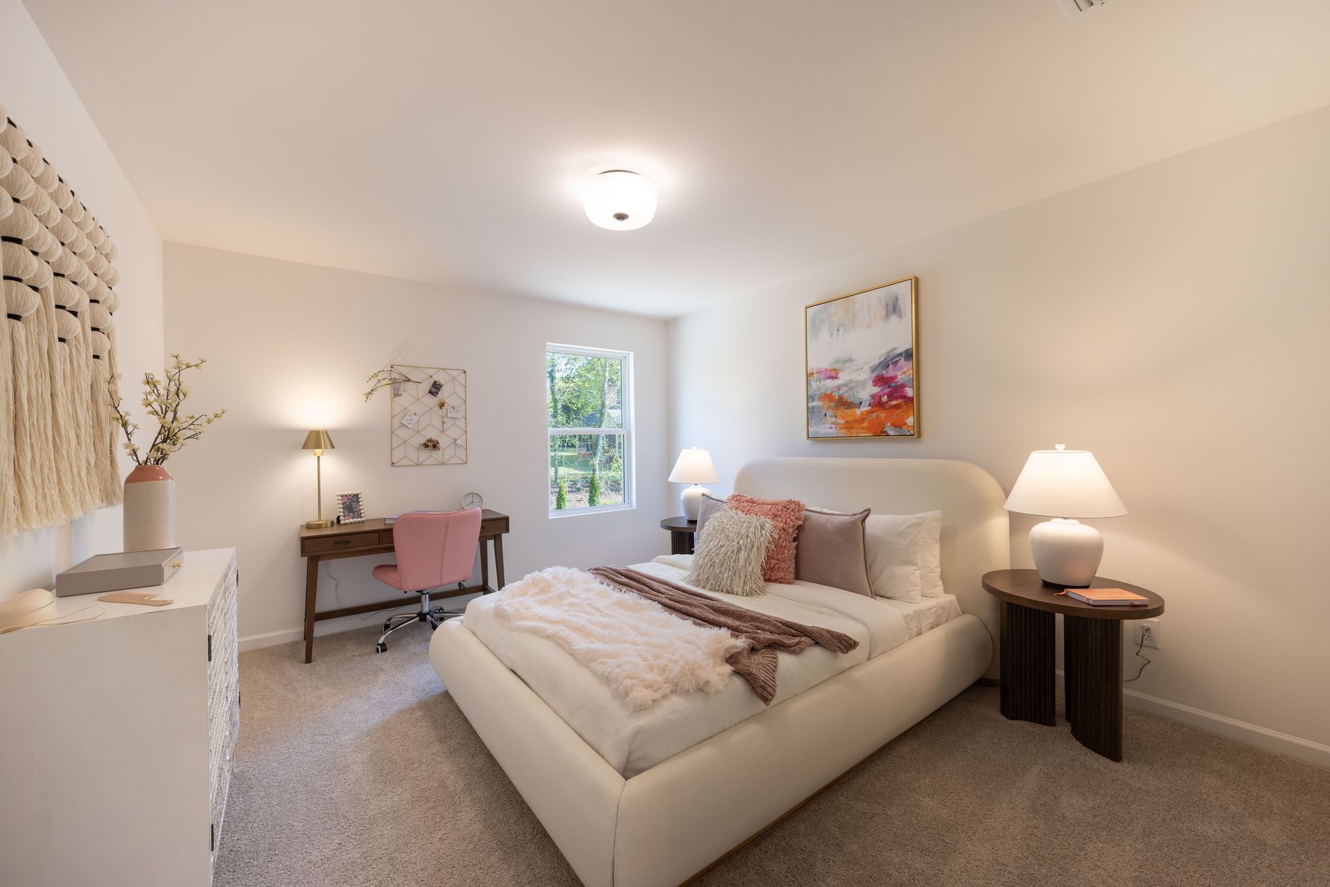 A bedroom with a large bed and a desk - Abigale Floorplan by True Homes.