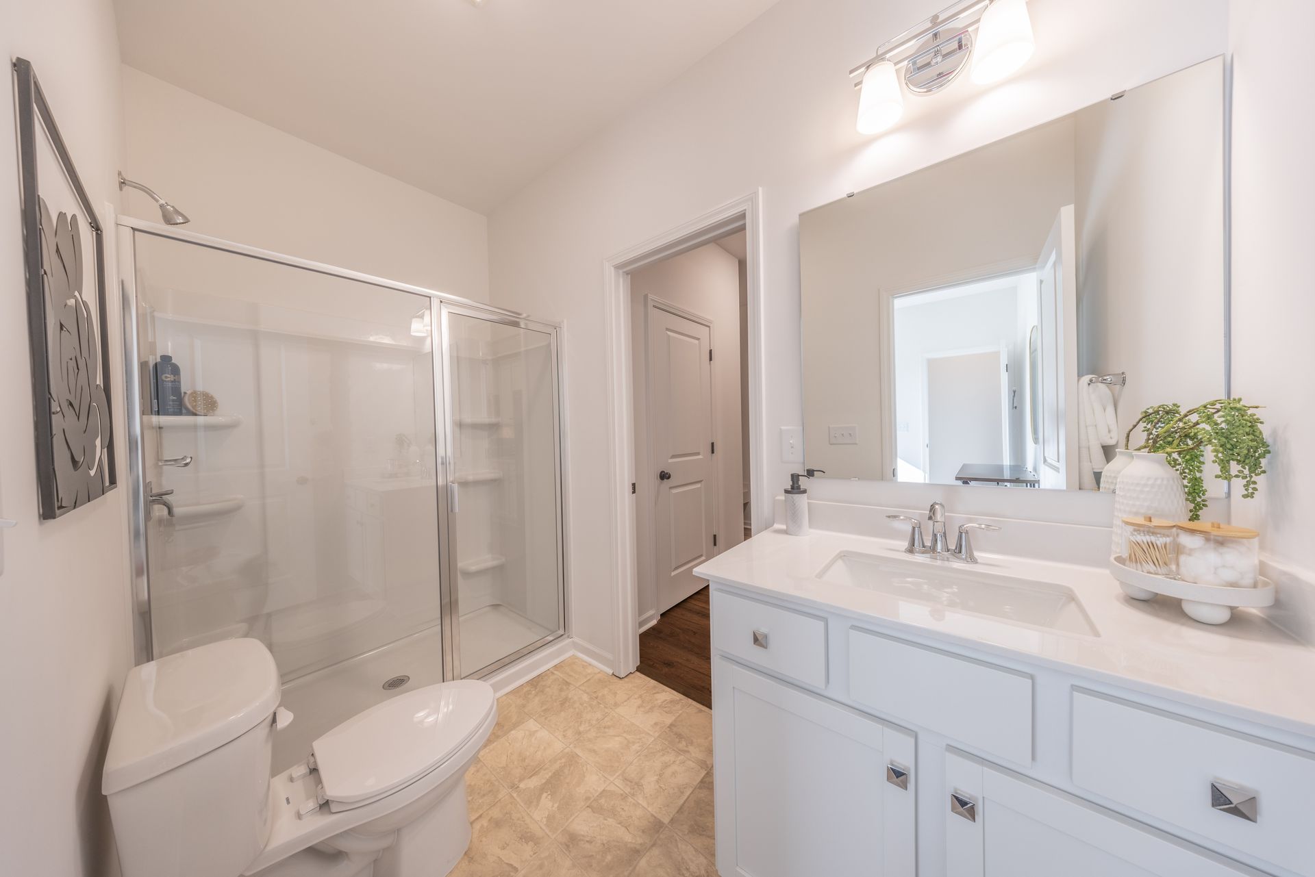 A bathroom with a toilet , sink , and shower - Abigale Floorplan by True Homes.