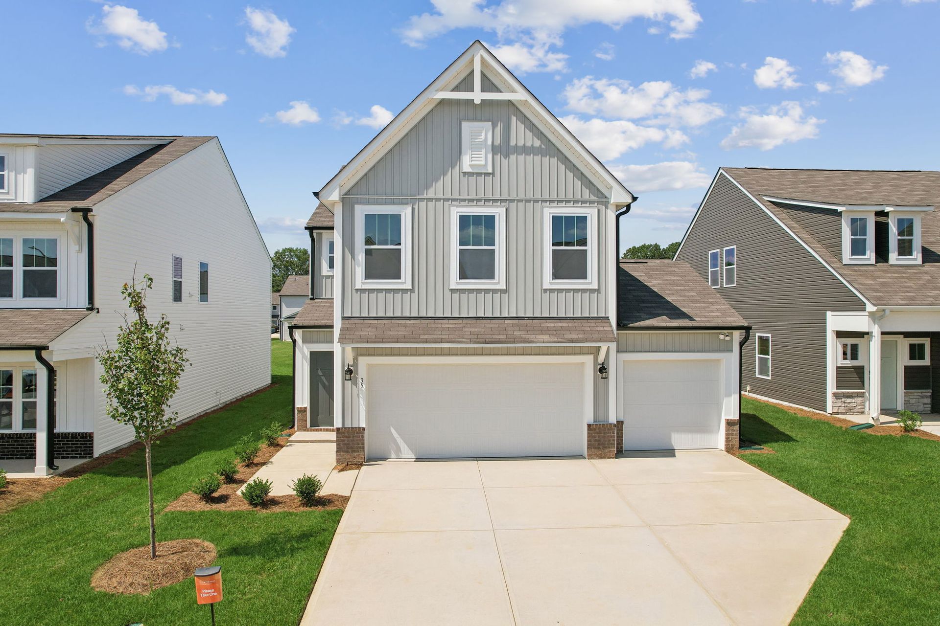 The front of a house with a large garage and a driveway.