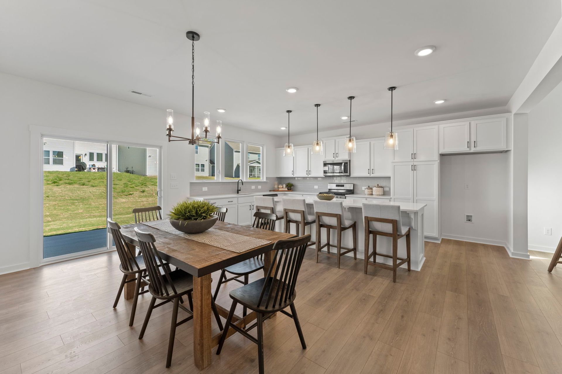 A kitchen and dining room in a house with a wooden table and chairs.