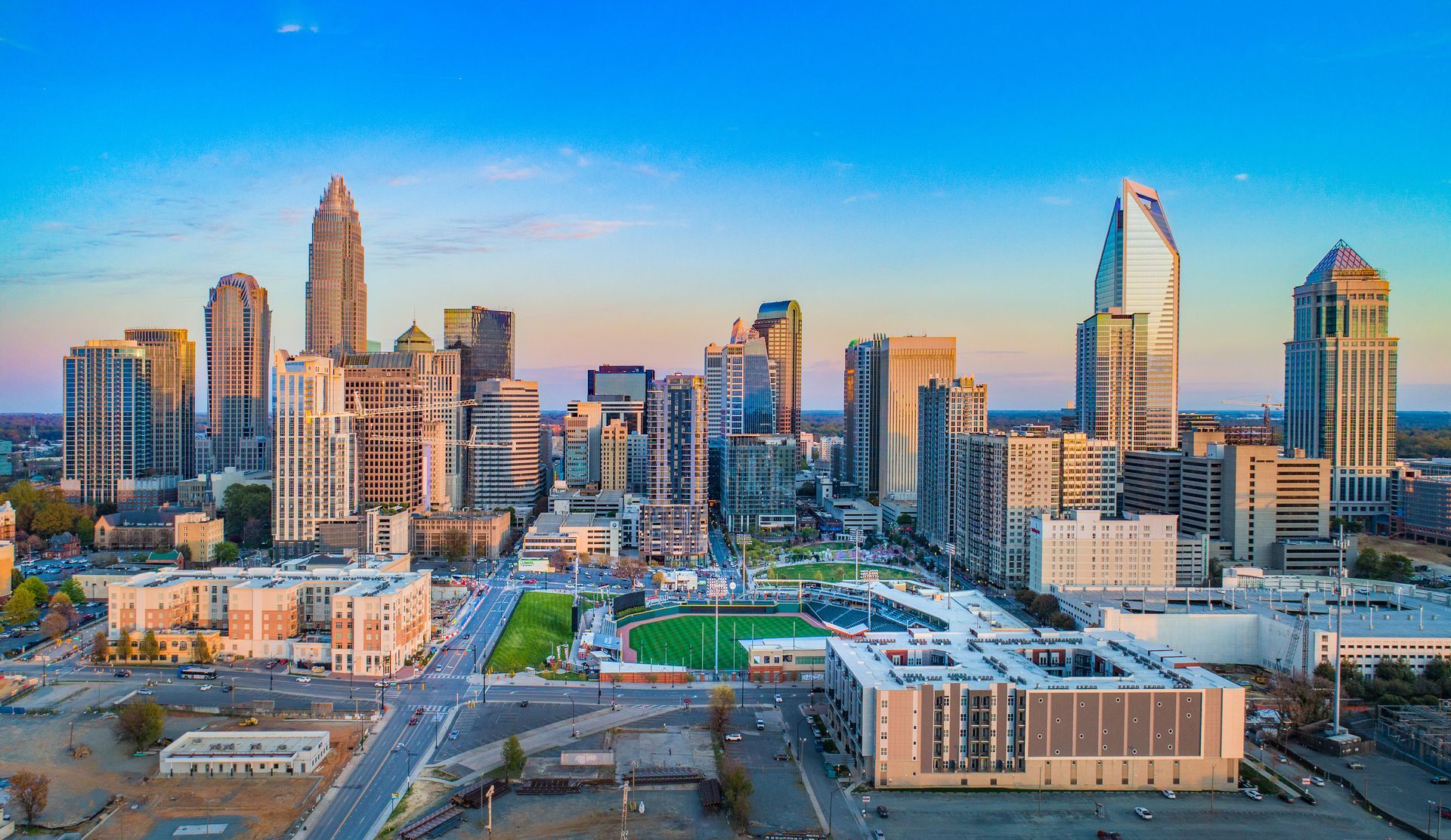 An aerial view of the city skyline at sunset.