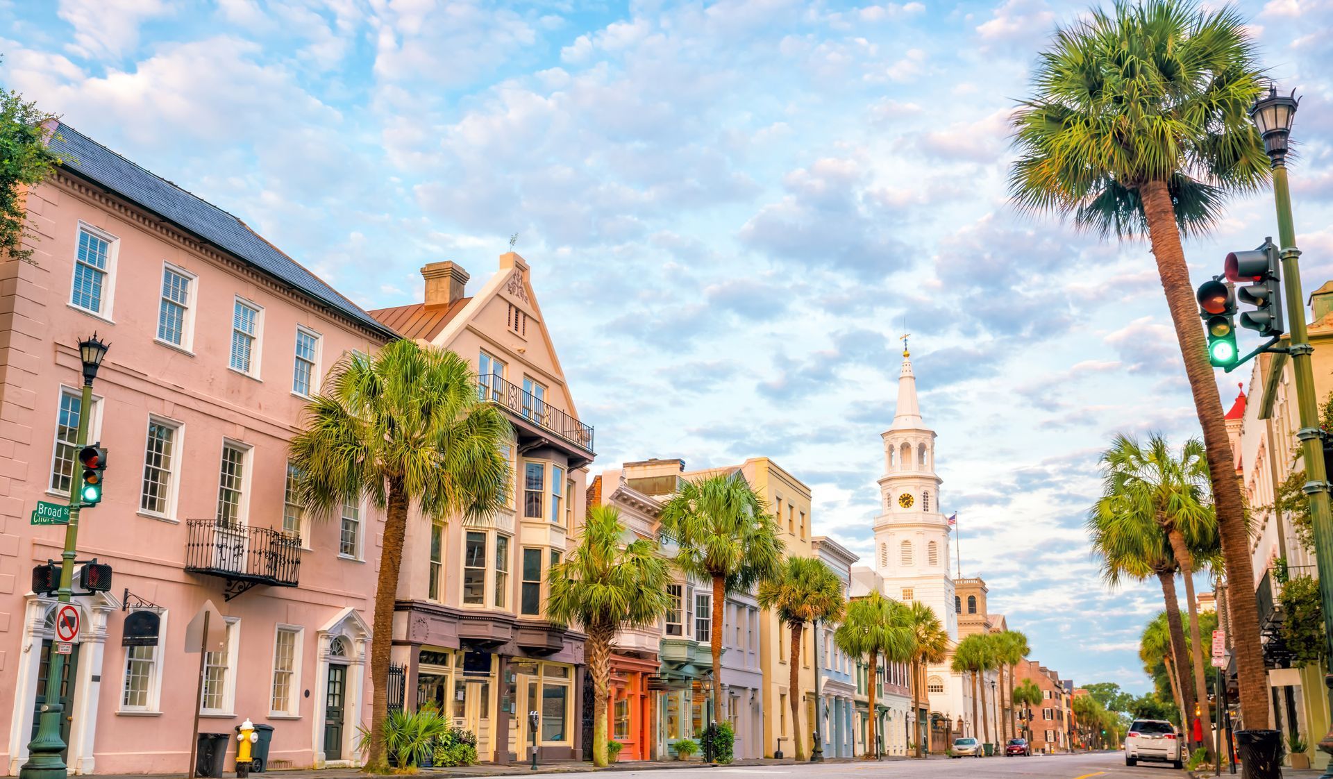 A city street with a lot of buildings and palm trees.