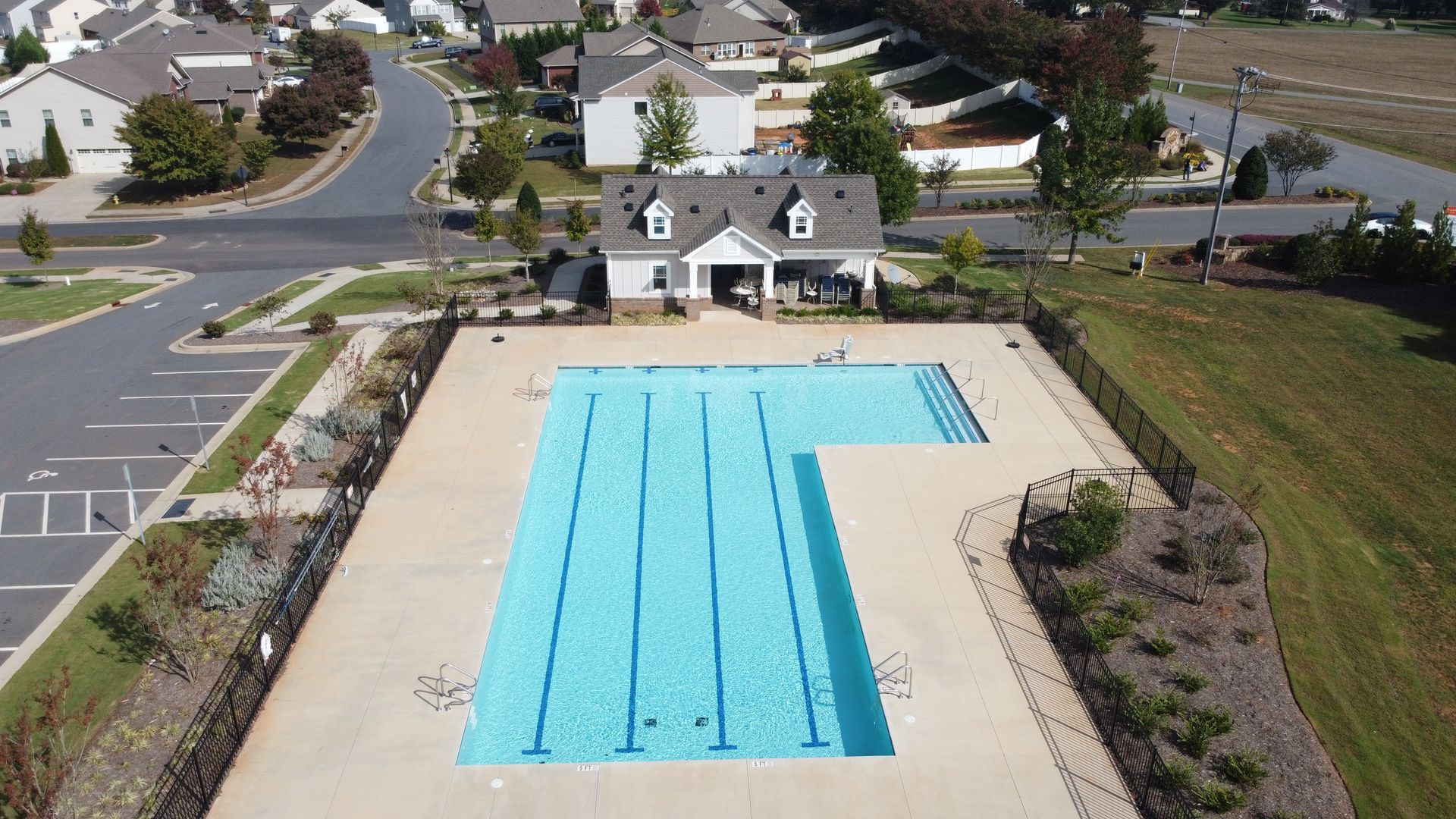 An aerial view of a large swimming pool in a residential area