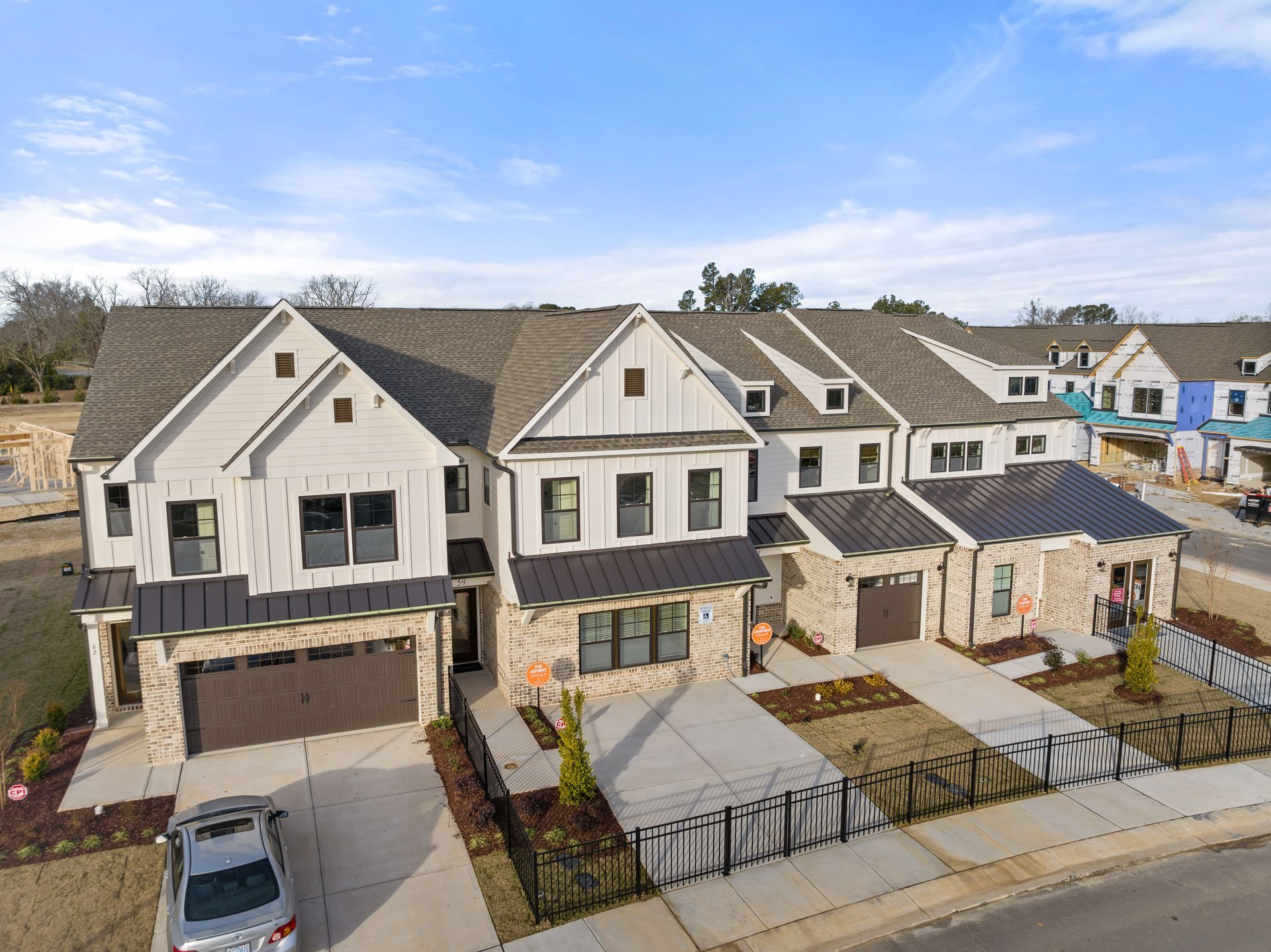 an aerial view of a row of houses with a car parked in front of them .