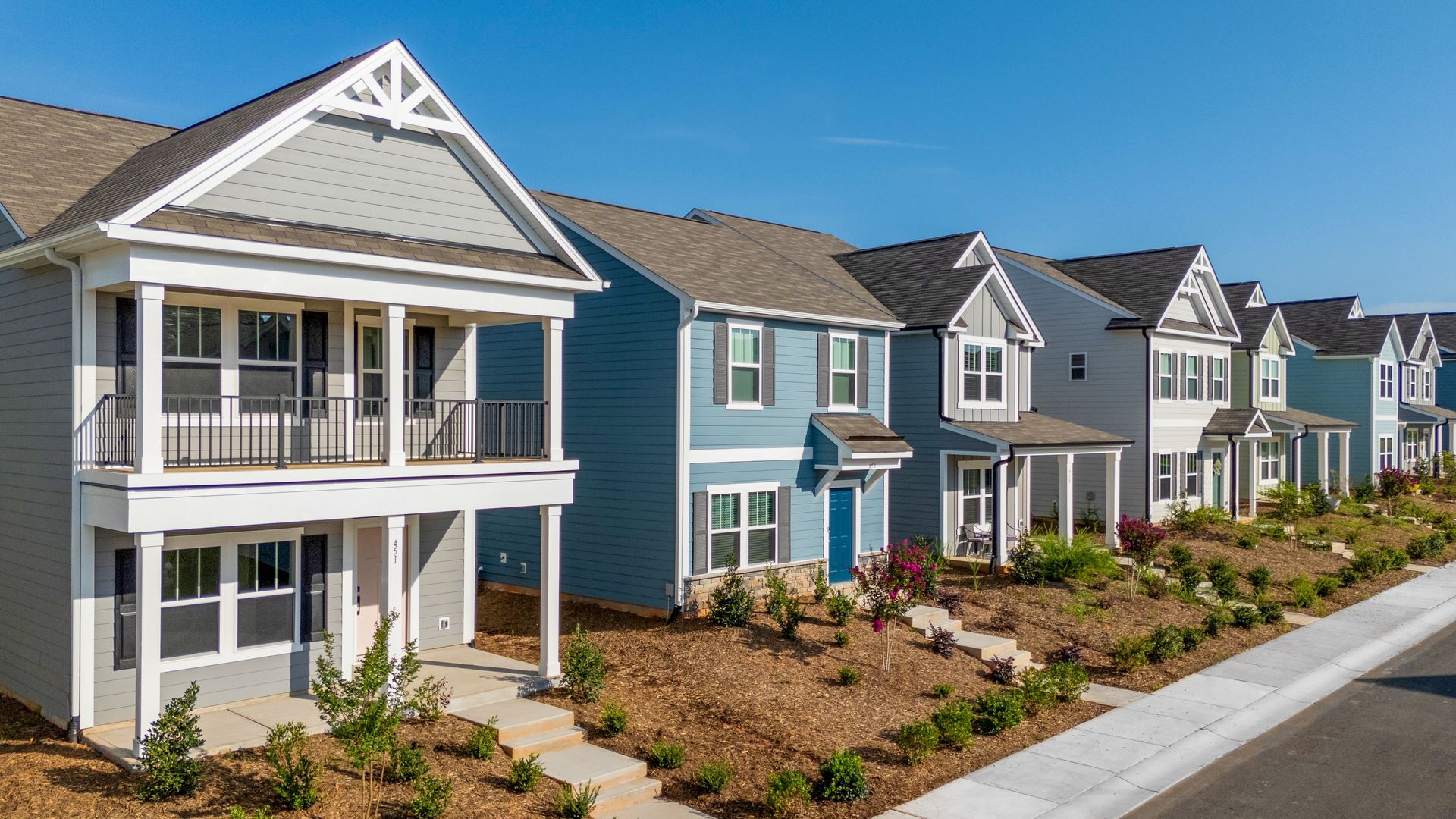 A row of houses are lined up next to each other in a residential area.