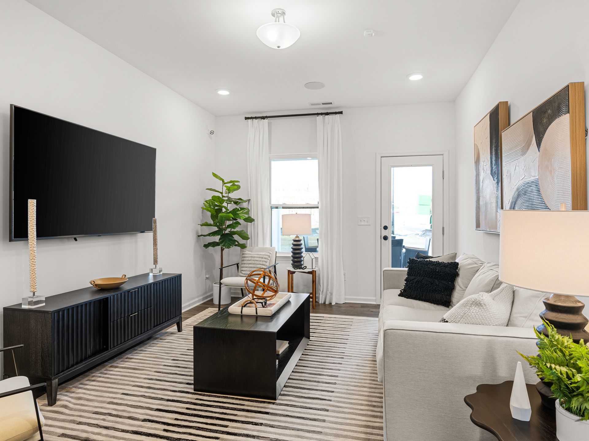 A living room with a couch and a flat screen tv.