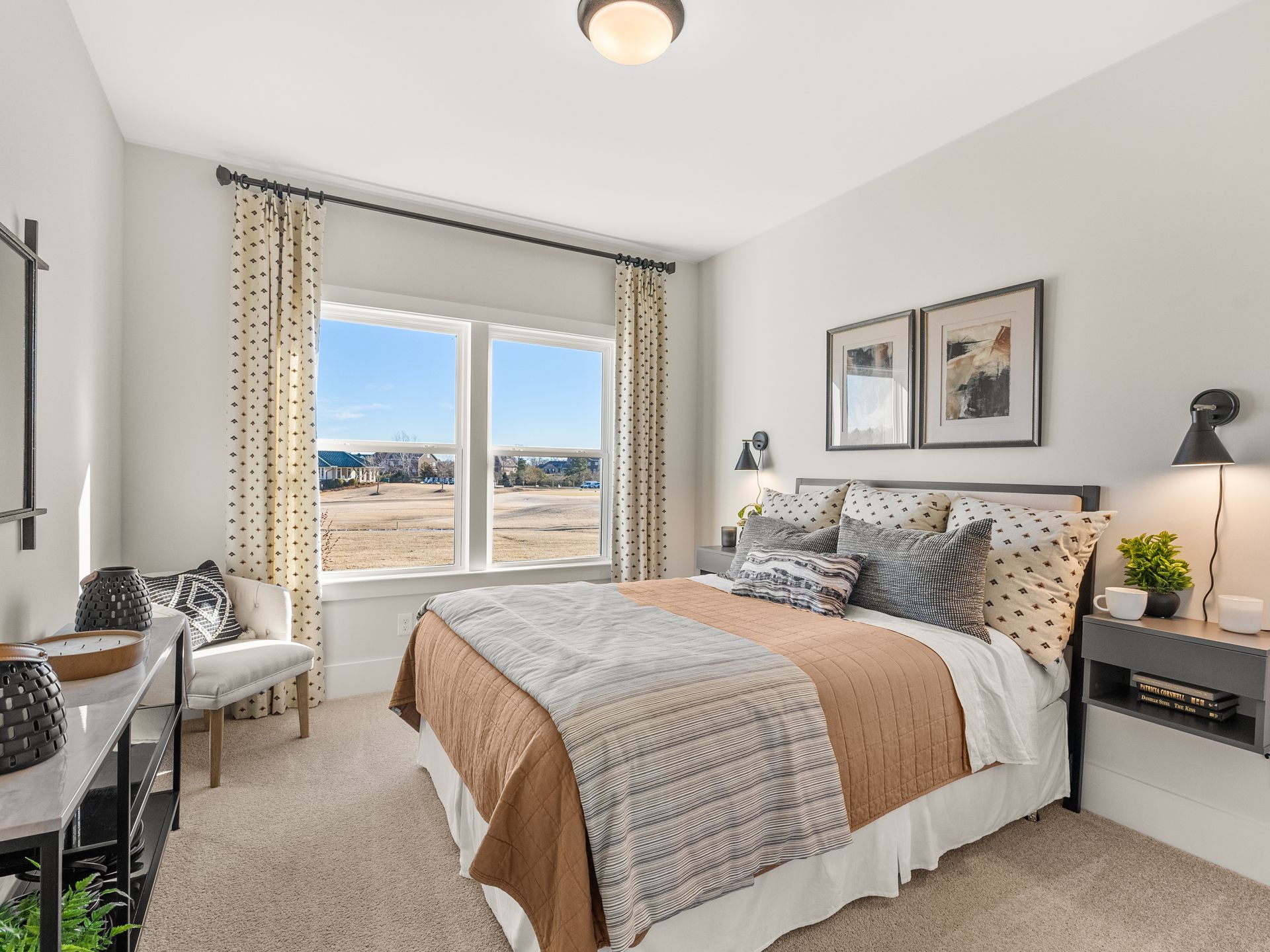 A bedroom with a large bed and a large window.