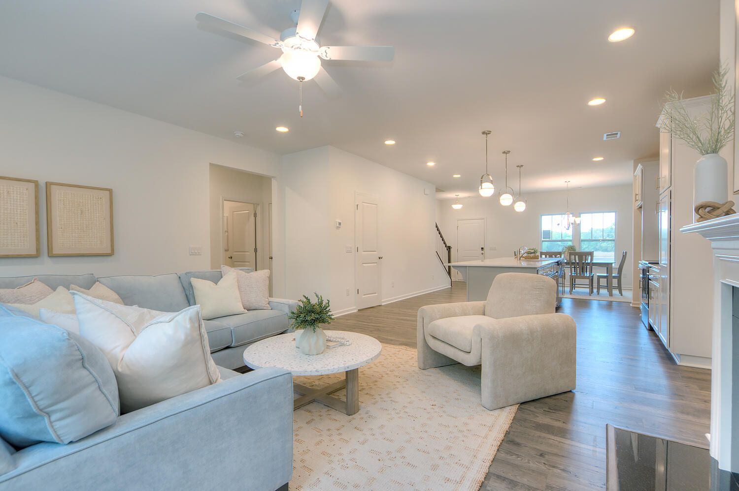 A living room filled with furniture and a ceiling fan.