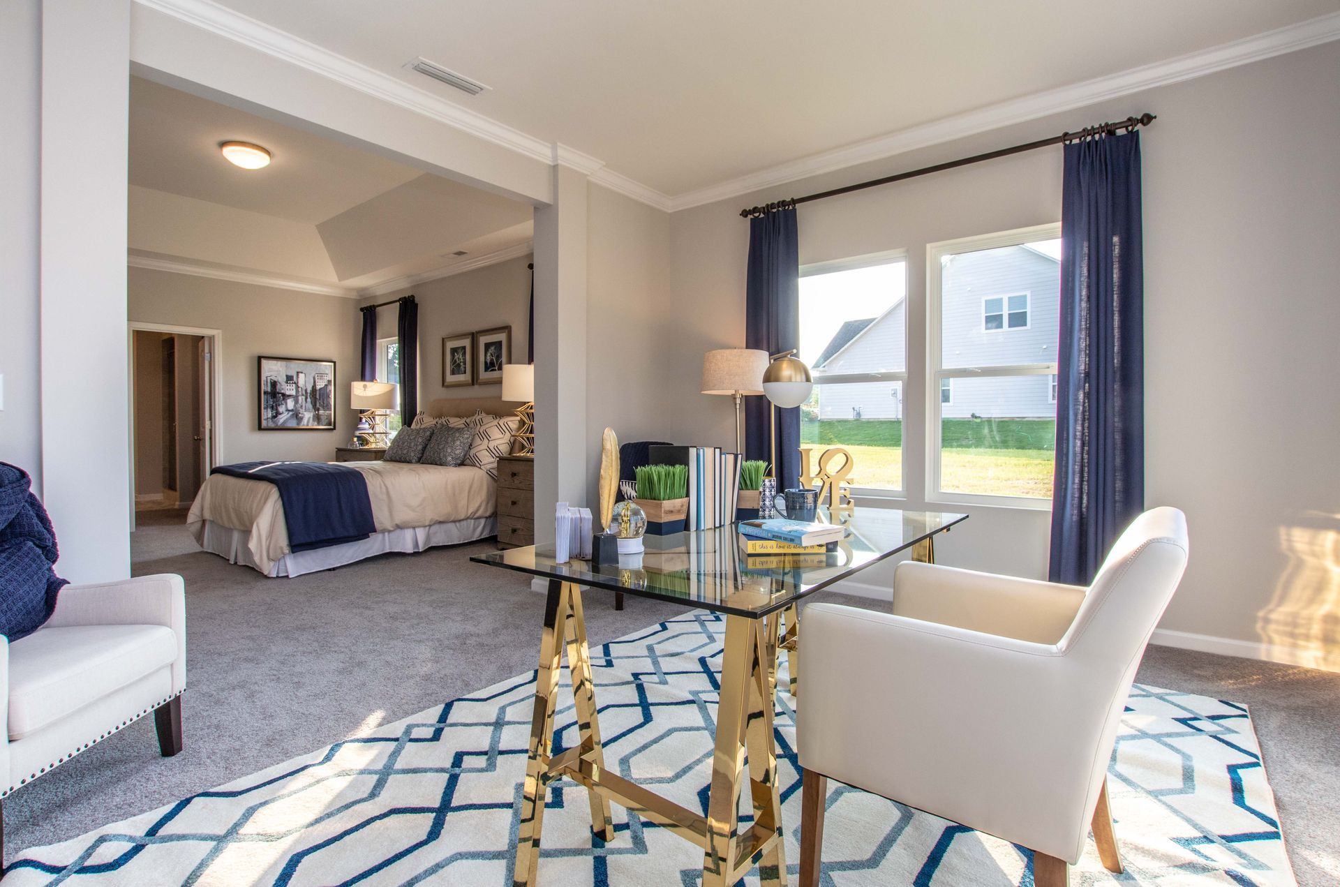 A bedroom with a desk , chair , and bed.