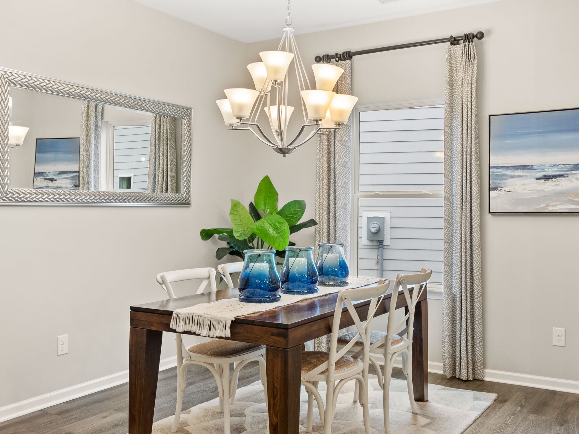A dining room with a table and chairs and a chandelier.