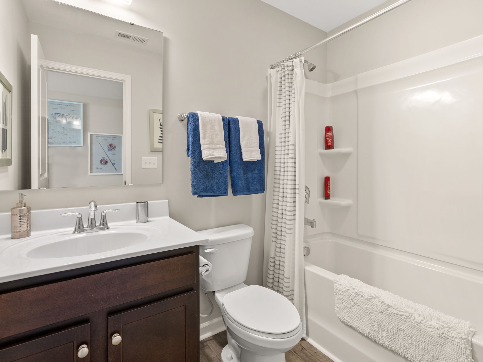 A bathroom with a toilet , sink , and bathtub.