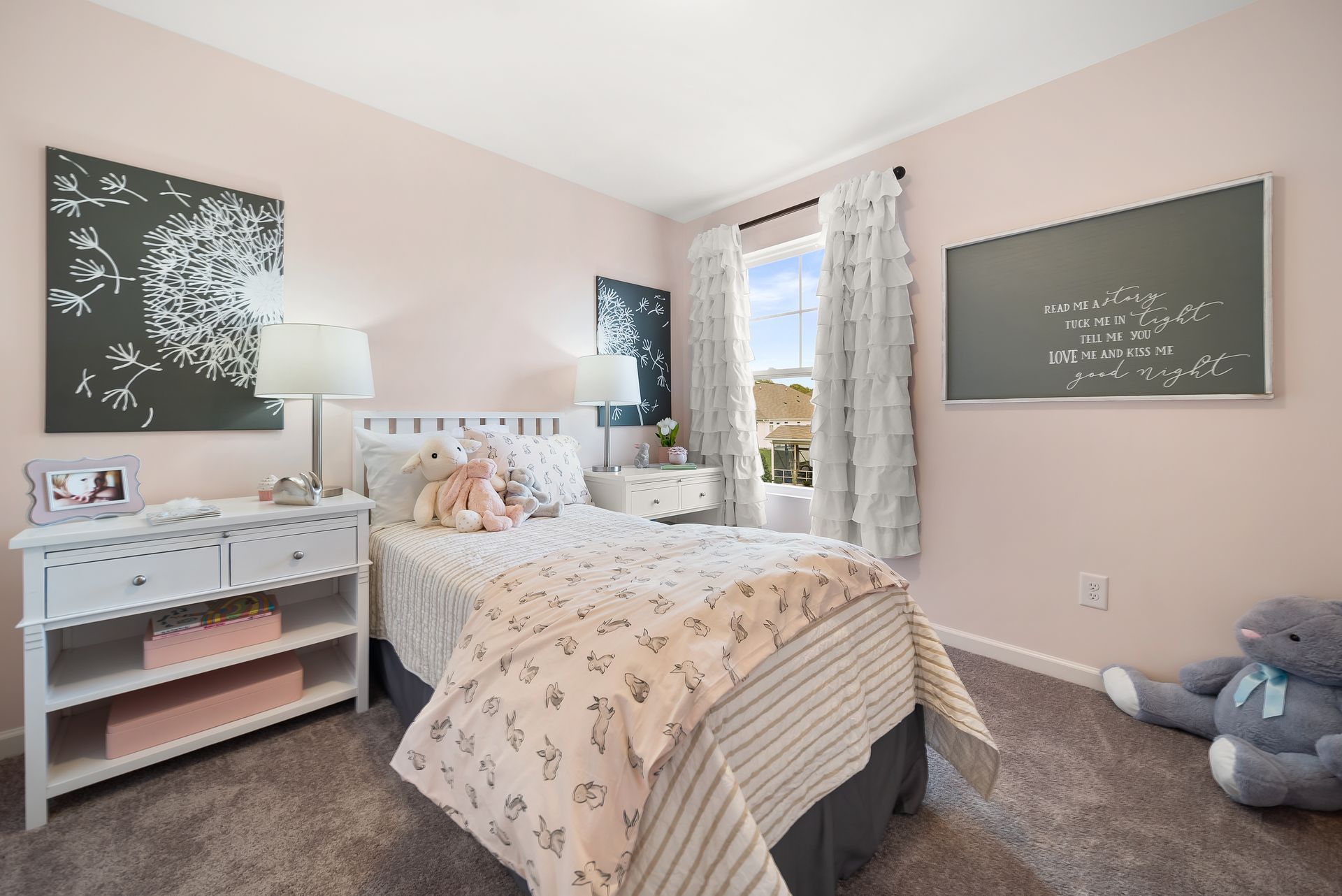A bedroom with a bed and a chalkboard on the wall