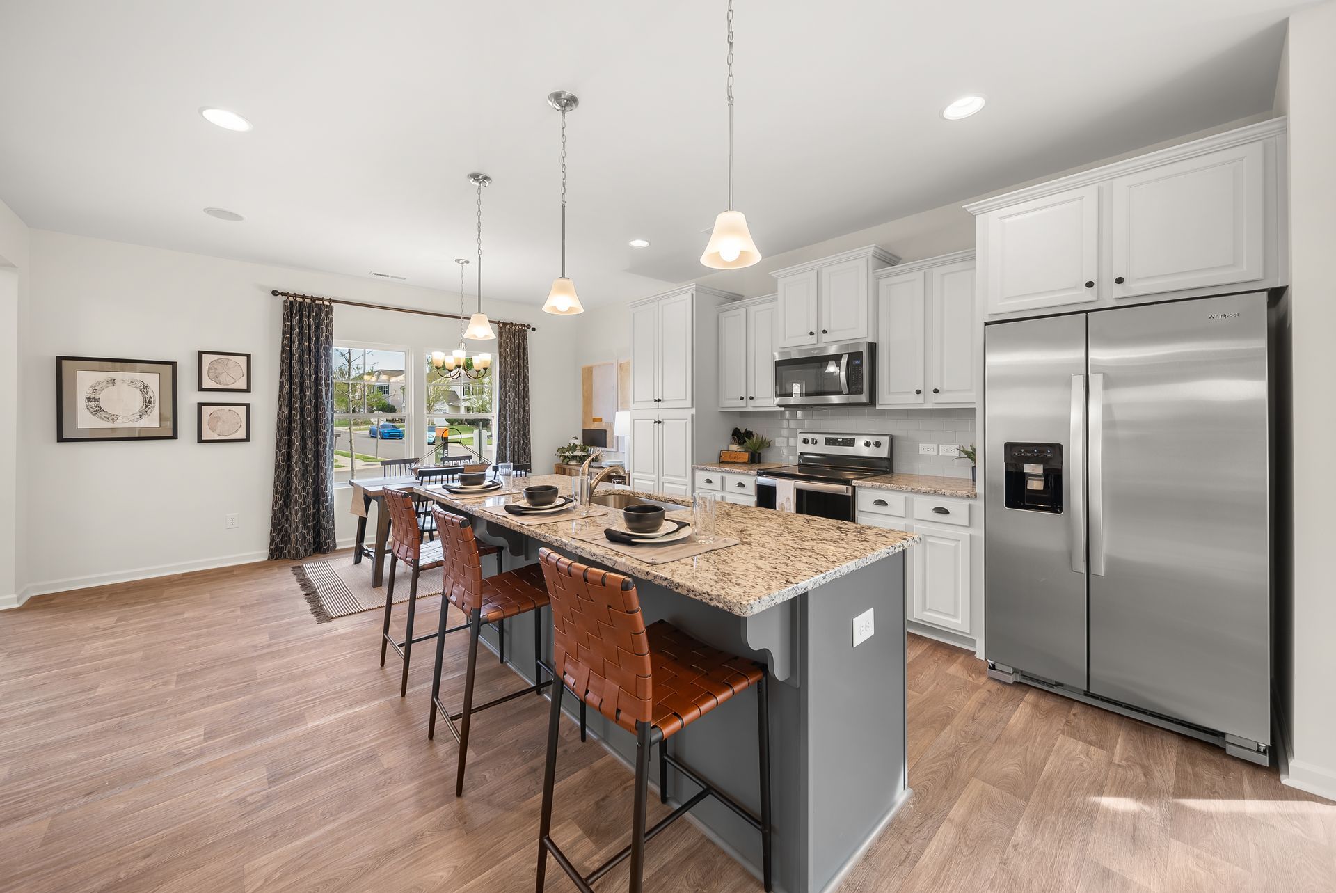 A kitchen with stainless steel appliances , granite counter tops , and a large island.