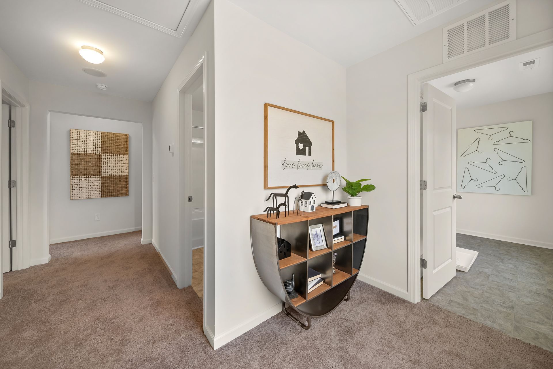 A hallway with a shelf and a picture on the wall.