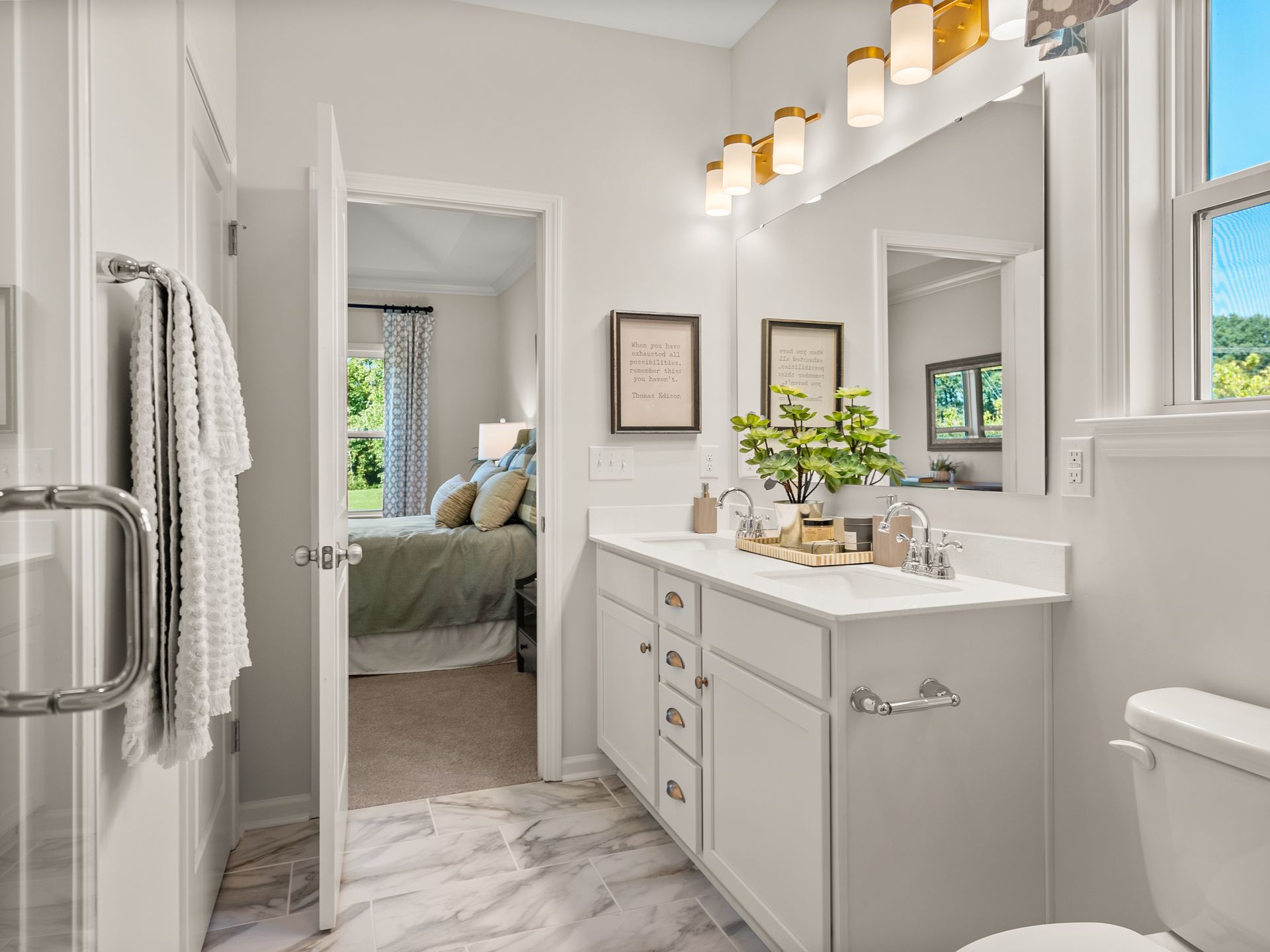 A bathroom with two sinks , a toilet , and a mirror.