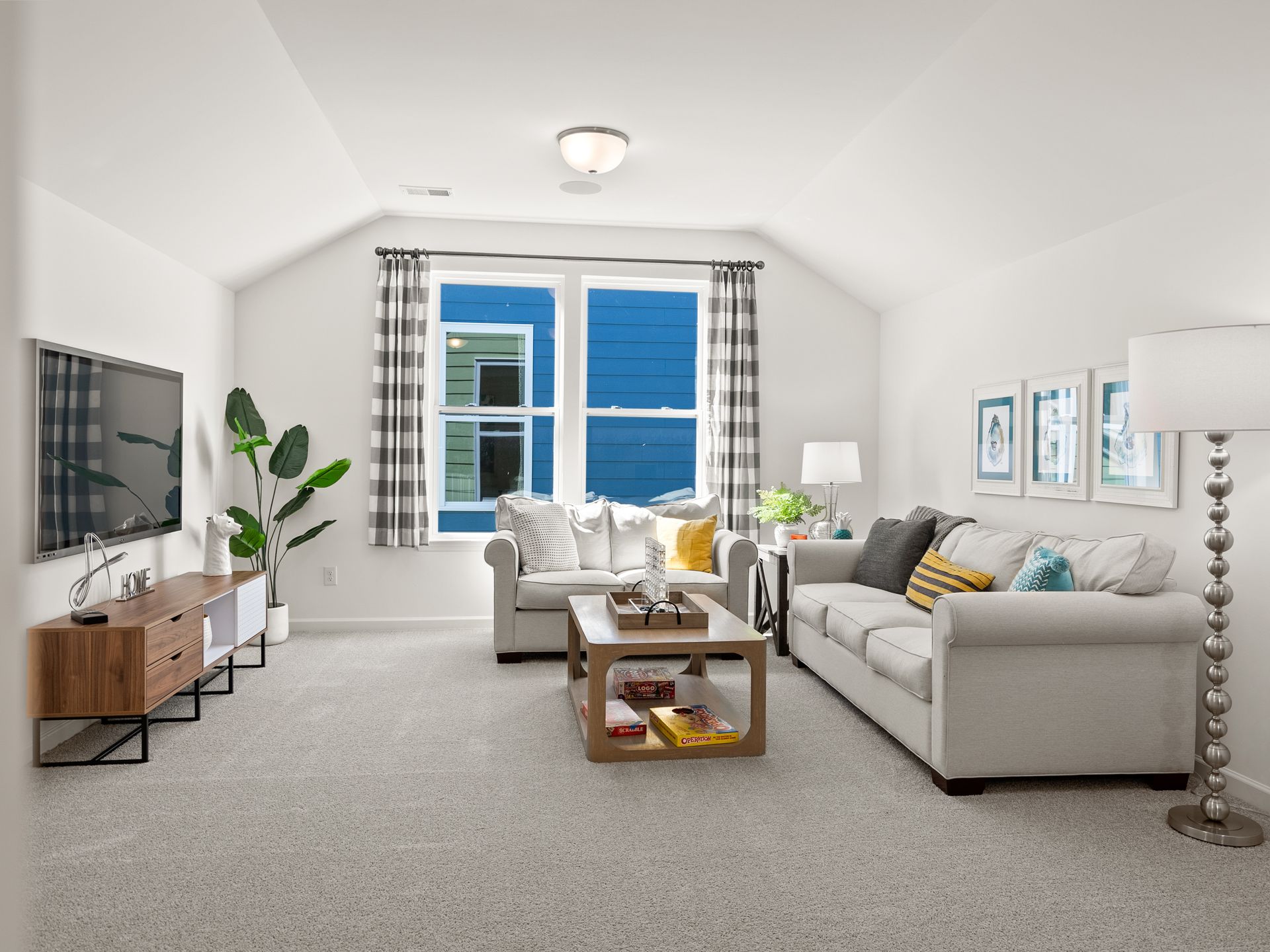 A living room with a couch , chair , coffee table and television.