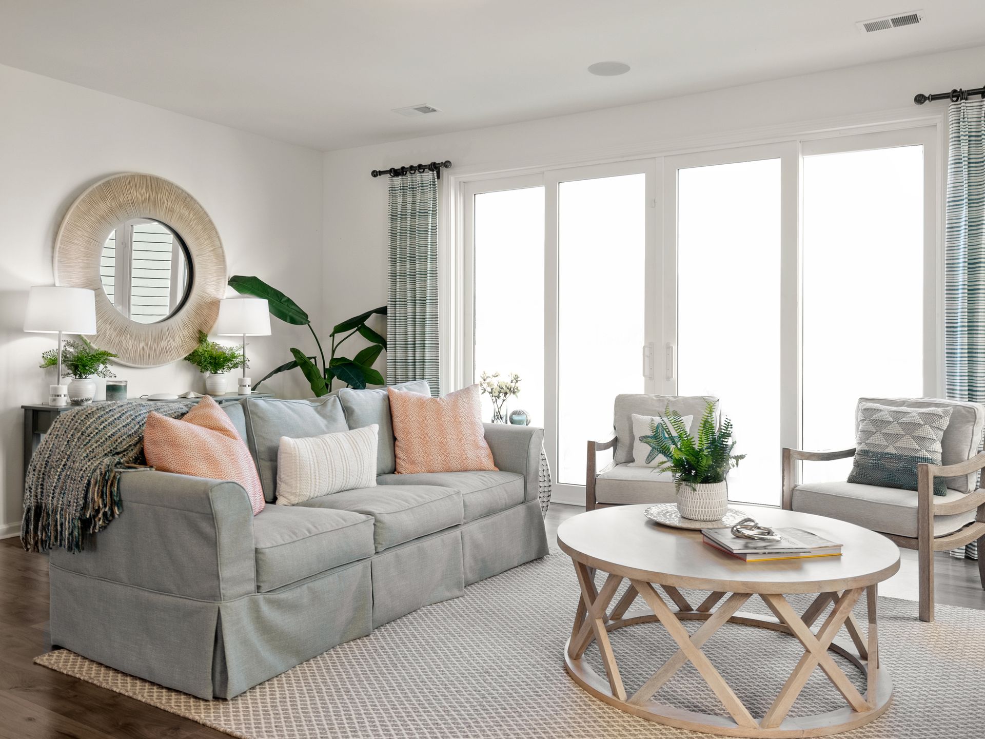A living room with a couch , chairs , and a coffee table.